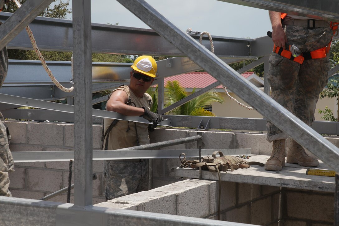 A U.S. Soldier, with the 372nd Engineer Company, positions a roof beam at the Ladyville, Belize Medical Clinic construction site, during Beyond the Horizon 2017, May 1st, 2017. Beyond the Horizon is a U.S. Southern Command-sponsored, Army South-led exercise designed to provide humanitarian and engineering services to communities in need, demonstrating U.S. support for Belize. (U.S. Army photo by Spc. Gary Silverman)