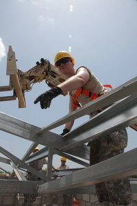 U.S. Army Spc. Chris Bebo, with the 372nd Engineer Company, directs the installation of roof beams at the Ladyville, Belize Medical Clinic construction site, during Beyond the Horizon 2017, May 1st, 2017. Beyond the Horizon is a U.S. Southern Command-sponsored, Army South-led exercise designed to provide humanitarian and engineering services to communities in need, demonstrating U.S. support for Belize. (U.S. Army photo by Spc. Gary Silverman)