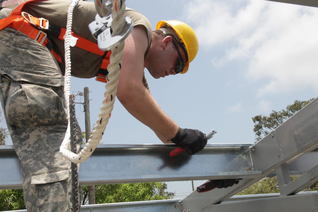 U.S. Army Pfc. Andrew Walter, with the 372nd Engineer Company, tightens the bolts of a beam for the roof at the Ladyville, Belize Medical Clinic construction site, during Beyond the Horizon 2017, May 1st, 2017. Beyond the Horizon is a U.S. Southern Command-sponsored, Army South-led exercise designed to provide humanitarian and engineering services to communities in need, demonstrating U.S. support for Belize. (U.S. Army photo by Spc. Gary Silverman)