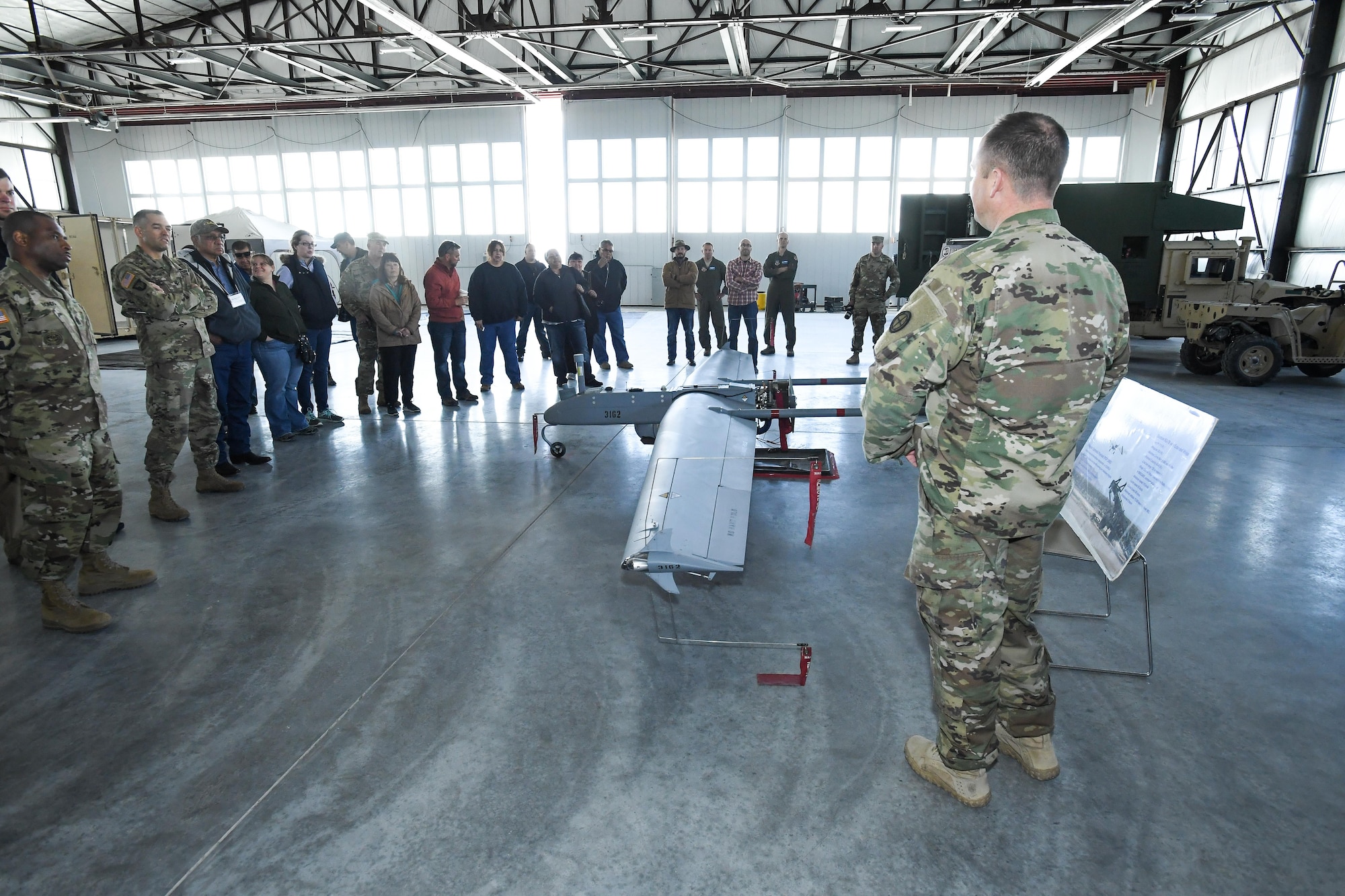 Representatives from American Indian tribes and DOD agencies are briefed on RQ-7B Shadow operations during a tour of the Utah National Guard's Unmanned Aerial System hangar, Wendover, Utah, April 28, 2017. Utah Department of Defense agencies hosted an annual face-to-face meeting April 27-28 with members of several American Indian Tribes who claim ancestral and ongoing ties to lands managed by the DOD agencies. Primary hosts for this year’s meeting, which was held in the adjacent cities of West Wendover, Nev., and Wendover, Utah, were Dugway Proving Ground and the Confederated Tribes of the Goshute Reservation. Hill Air Force Base, the Utah National Guard and Tooele Army Depot co-hosted the event. (U.S. Air Force photo/R. Nial Bradshaw)