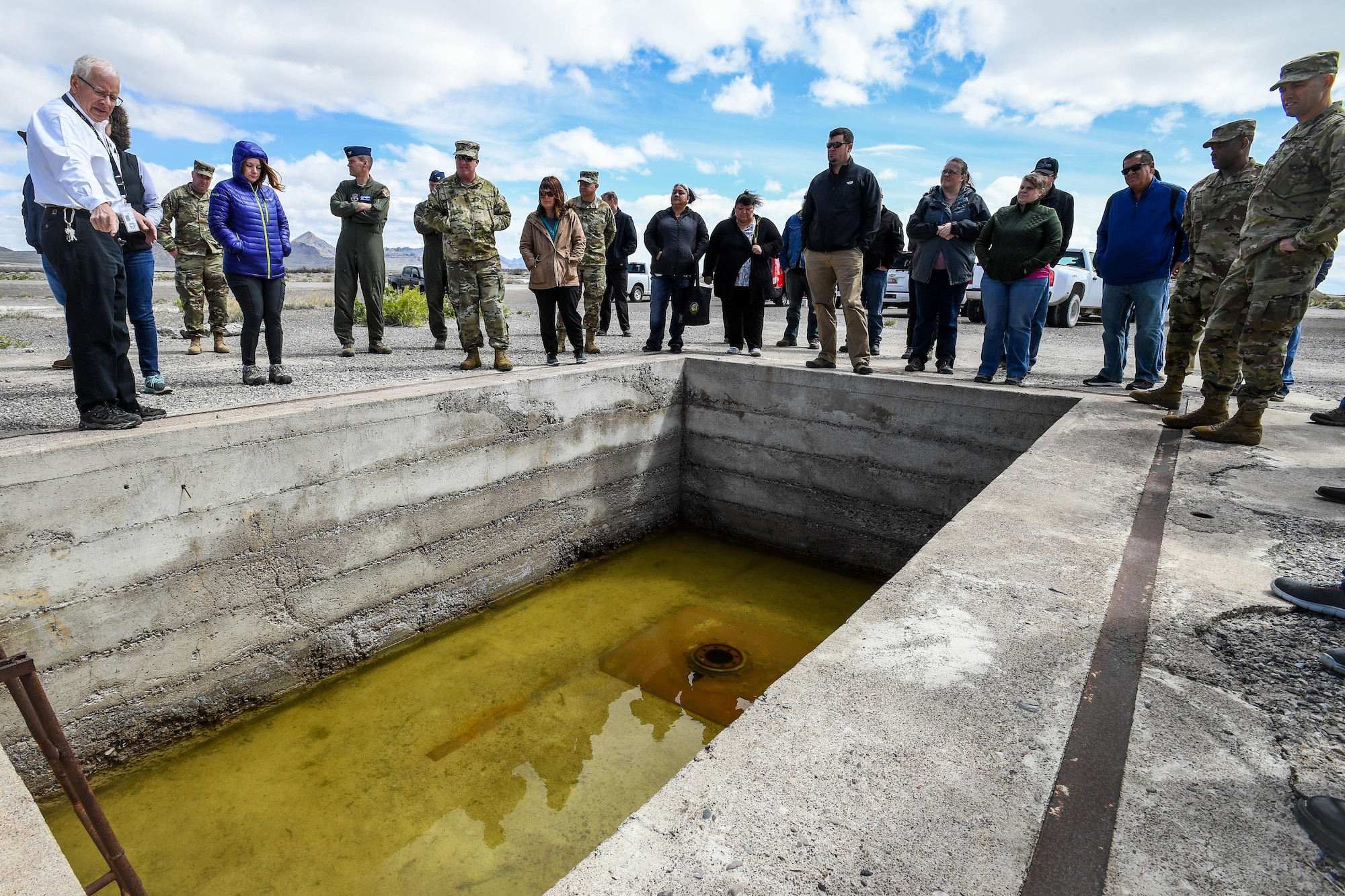 Historic Wendover Museum Foundation President Jim Petersen shows representatives from American Indian tribes and DOD agencies a bomb loading pit at Wendover Airfield, Wendover, Utah, April 28, 2017. Utah Department of Defense agencies hosted an annual face-to-face meeting April 27-28 with members of several American Indian Tribes who claim ancestral and ongoing ties to lands managed by the DOD agencies. Primary hosts for this year’s meeting, which was held in the adjacent cities of West Wendover, Nev., and Wendover, Utah, were Dugway Proving Ground and the Confederated Tribes of the Goshute Reservation. Hill Air Force Base, the Utah National Guard and Tooele Army Depot co-hosted the event. (U.S. Air Force photo/R. Nial Bradshaw)