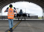 A Republic of Singapore Air Force service member marshalls an F-15SG April 10, 2017, at Andersen Air Force Base, Guam. The RSAF is deployed here to conduct bilateral training for aircrew and maintenance personnel to sharpen their skills and strengthen ties with partners in the Pacific.