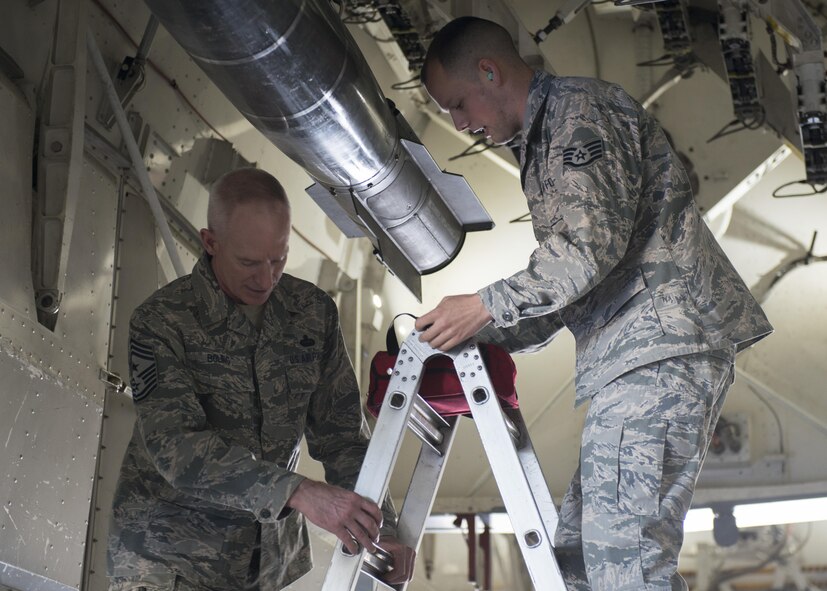 U.S. Air Force Chief Master Sgt. Alan Boling, 8th Air Force command chief, observes a Joint Air-to-Surface Standoff Missile load at the Weapons Load Barn May 2, 2017 at Dyess Air Force Base, Texas. Boling used his visit as an opportunity to better understand how Dyess Weapons Airmen provide combat-ready B-1 aircraft for combatant commanders. (U.S. Air Force photo by Airman 1st Class Katherine Miller)