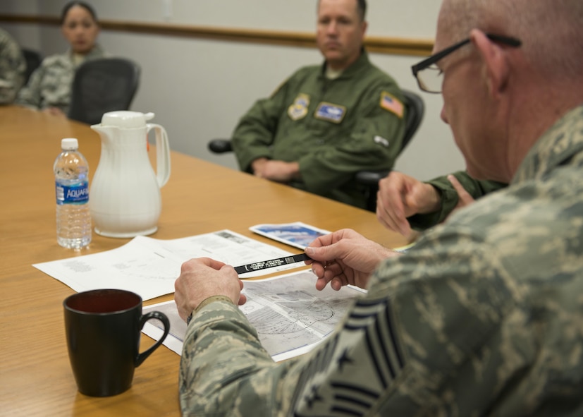 U.S. Air Force Chief Master Sgt. Alan Boling, 8th Air Force command chief, receives a unit patch and bracelet memorializing TORQUE 62 Airmen killed May 2, 2017 at Dyess Air Force Base, Texas. The four Dyess Airmen were killed in a C-130J Super Hercules crash Oct. 2, 2015 in Jalalabad, Afghanistan. Boling was also briefed on the proposed plans to expand and upgrade the Dyess Memorial Park, set to honor all fallen Airmen of Dyess while on station or overseas. (U.S. Air Force photo by Airman 1st Class Katherine Miller)