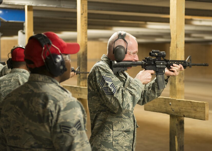 U.S. Air Force Chief Master Sgt. Alan Boling, 8th Air Force command chief, fires an M4 at the Combat Arms Training and Maintenance facility during his visit to Dyess Air Force Base, Texas, May 2, 2107. CATM instructors are responsible for maintaining and repairing firearms as well as educating military members the correct way to use and handle weapons while on station or deployed. (U.S. Air Force photo by Airman 1st Class Katherine Miller)