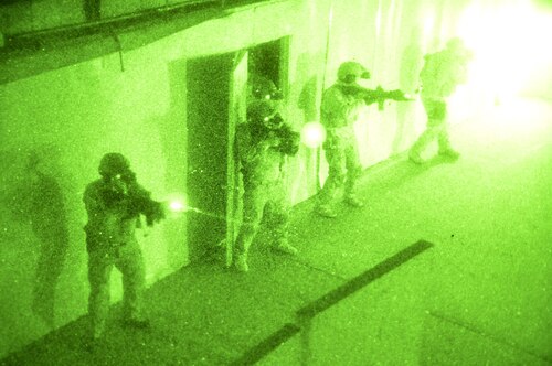 Navy SEALs clear a room during a no-light live-fire drill near San Diego, Dec. 4, 2015. Naval Special Warfare reservists from a combat service support unit conducted a field training exercise based on principles from the expeditionary warfare community. Navy photo by Petty Officer 1st Class Daniel Stevenson