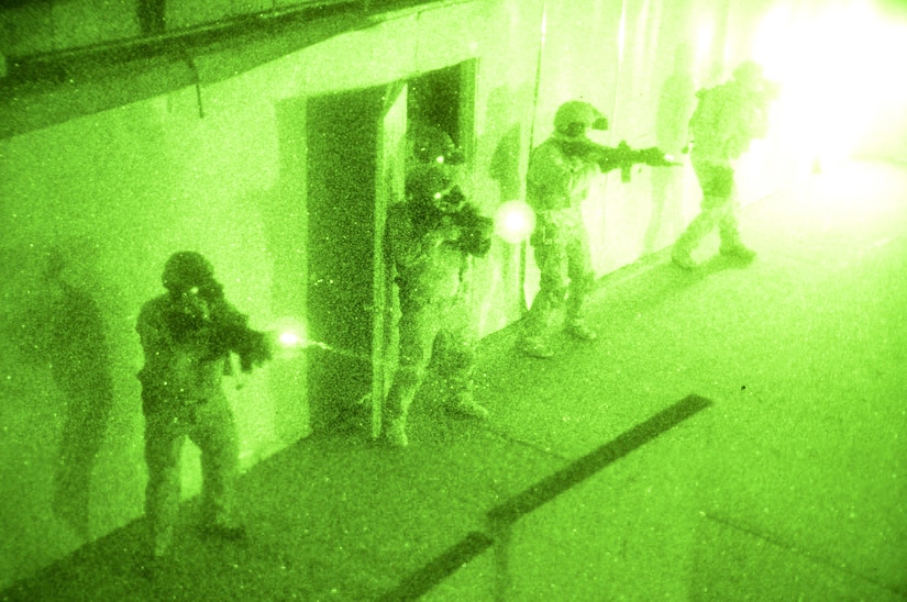 Navy SEALs clear a room during a no-light live-fire drill near San Diego, Dec. 4, 2015. Naval Special Warfare reservists from a combat service support unit conducted a field training exercise based on principles from the expeditionary warfare community. Navy photo by Petty Officer 1st Class Daniel Stevenson