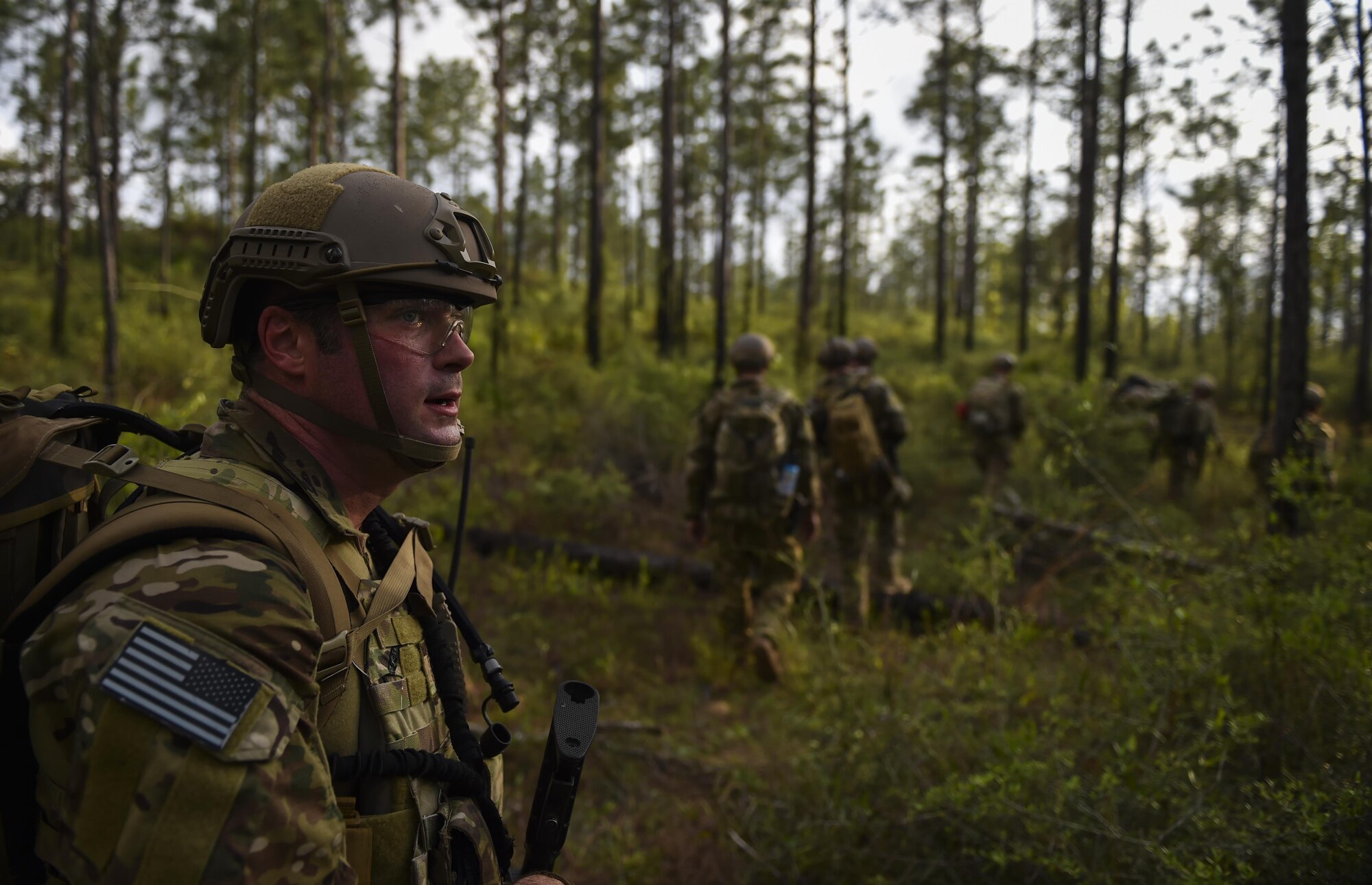 Maj. Justin Mahoney, a combat aviation advisor student with the 6th Special Operations Squadron, provides rear security for his team during Operation Raven Claw at Duke Field, Fla., April 27, 2017. Students came under simulated fire from hostile forces during a checkpoint and had to navigate through the woods to a safe location while carrying a casualty weighing approximately 210 pounds. (U.S. Air Force photo by Airman 1st Class Joseph Pick)