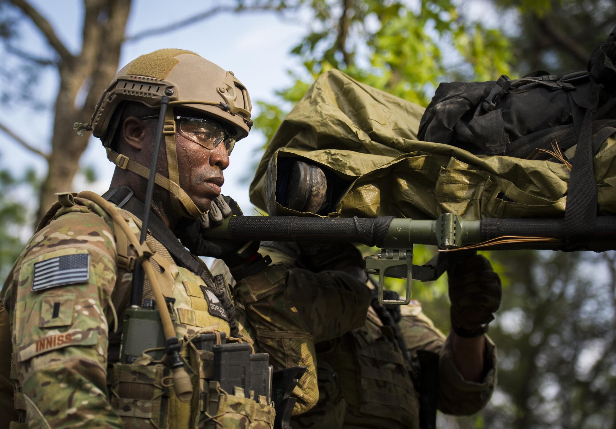 First Lt. Korde Inniss, a combat aviation advisor student with the 6th Special Operations Squadron, carries a litter through the woods during Operation Raven Claw at Duke Field, Fla., April 27, 2017. Students came under simulated fire from hostile forces during a checkpoint and had to navigate through the woods to a safe location while carrying a casualty weighing approximately 210 pounds. (U.S. Air Force photo by Airman 1st Class Joseph Pick)