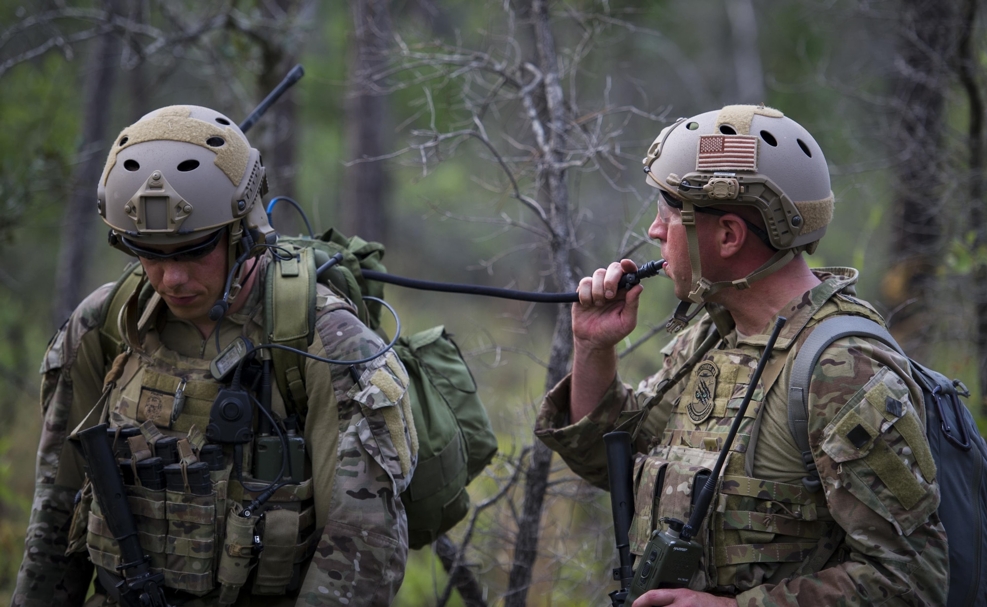 Lt. Col. Benjamin Griffith, right, a combat aviation advisor with the 6th Special Operations Squadron, drinks water from Capt. Cole Geldernick, a CAA with the 6th SOS, during Operation Raven Claw at Duke Field, Fla., April 27, 2017. Throughout Raven Claw, students faced different scenarios such as providing casualty treatment for local civilians, handling potential human rights violations and reacting to improvised explosions during the middle of the night. (U.S. Air Force photo by Airman 1st Class Joseph Pick)