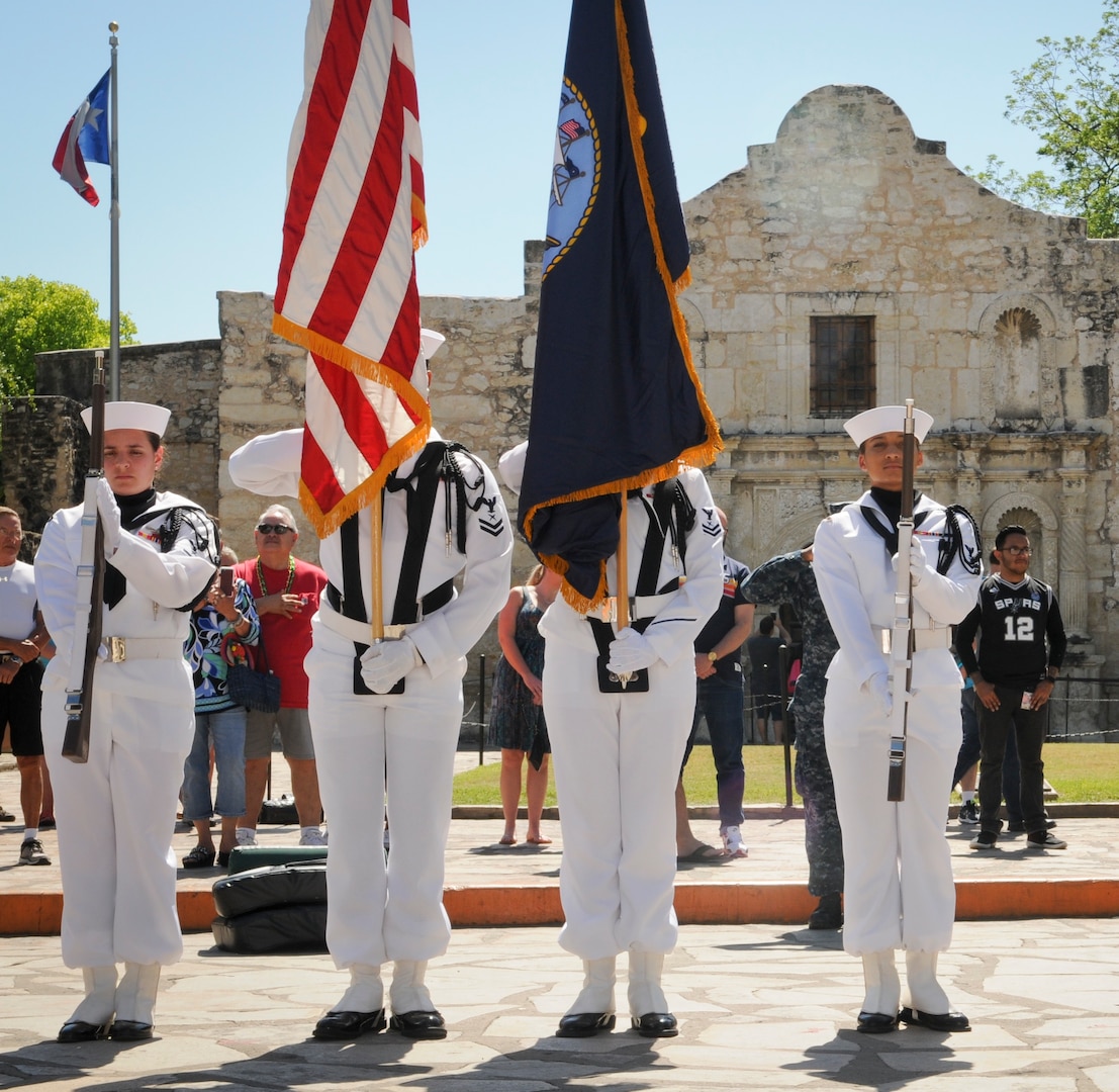 A Navy color guard unit parades the colors during Navy Day at the Alamo as part of Fiesta in downtown San Antonio. Ten different Navy commands in the San Antonio area gathered to celebrate with local military and community leaders.