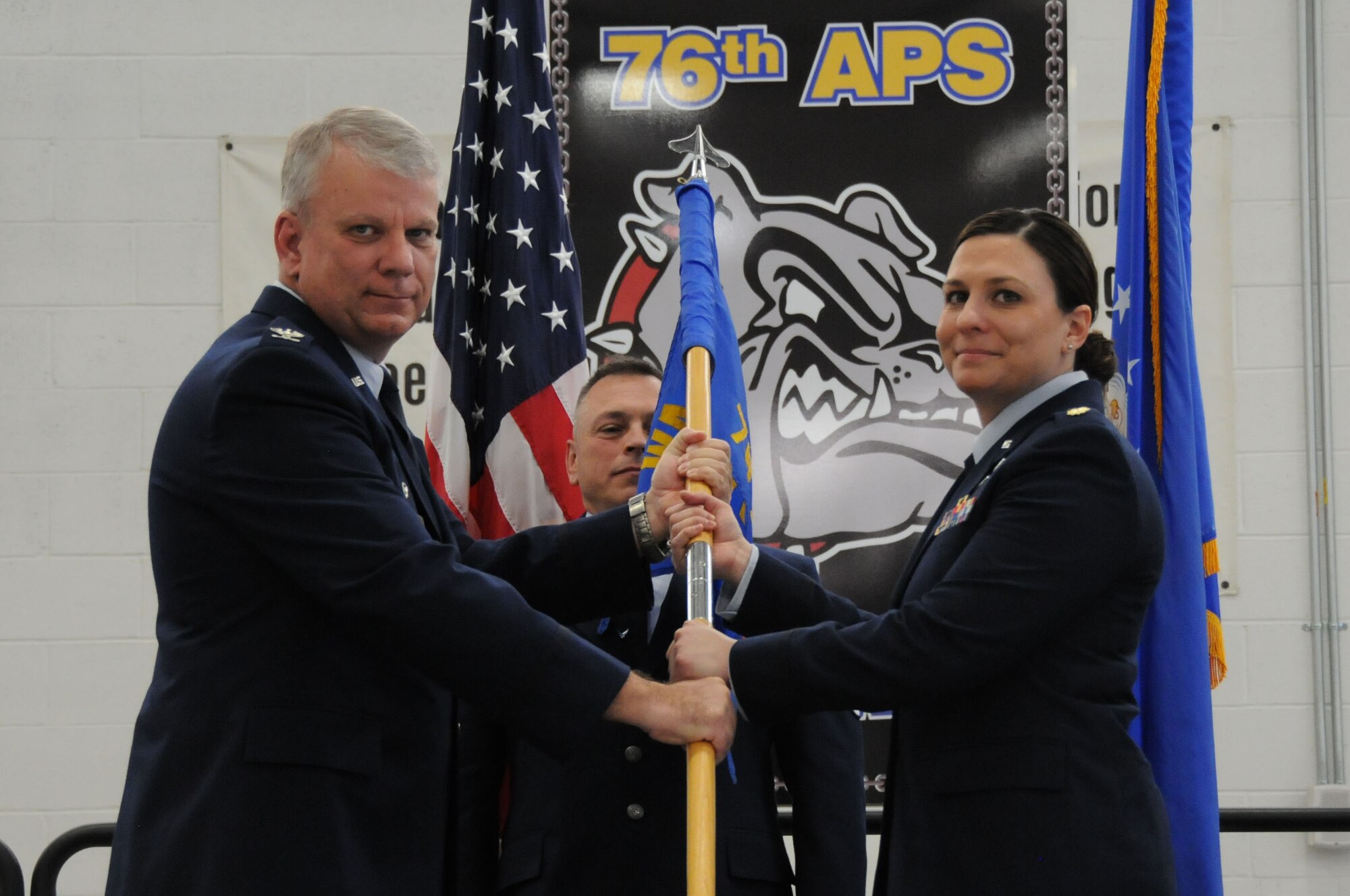 Maj. Elisa Van Cise, new commander of the 76th Aerial Port Squadron, receives the unit guidon, or flag, from Col. Donald Wren, 910th Mission Support Group commander, during a change of command ceremony April 2, 2017. Van Cise took command from Lt. Col. Gregory Meyer. (U.S. Air Force photo/Senior Airman Joshua Kincaid)