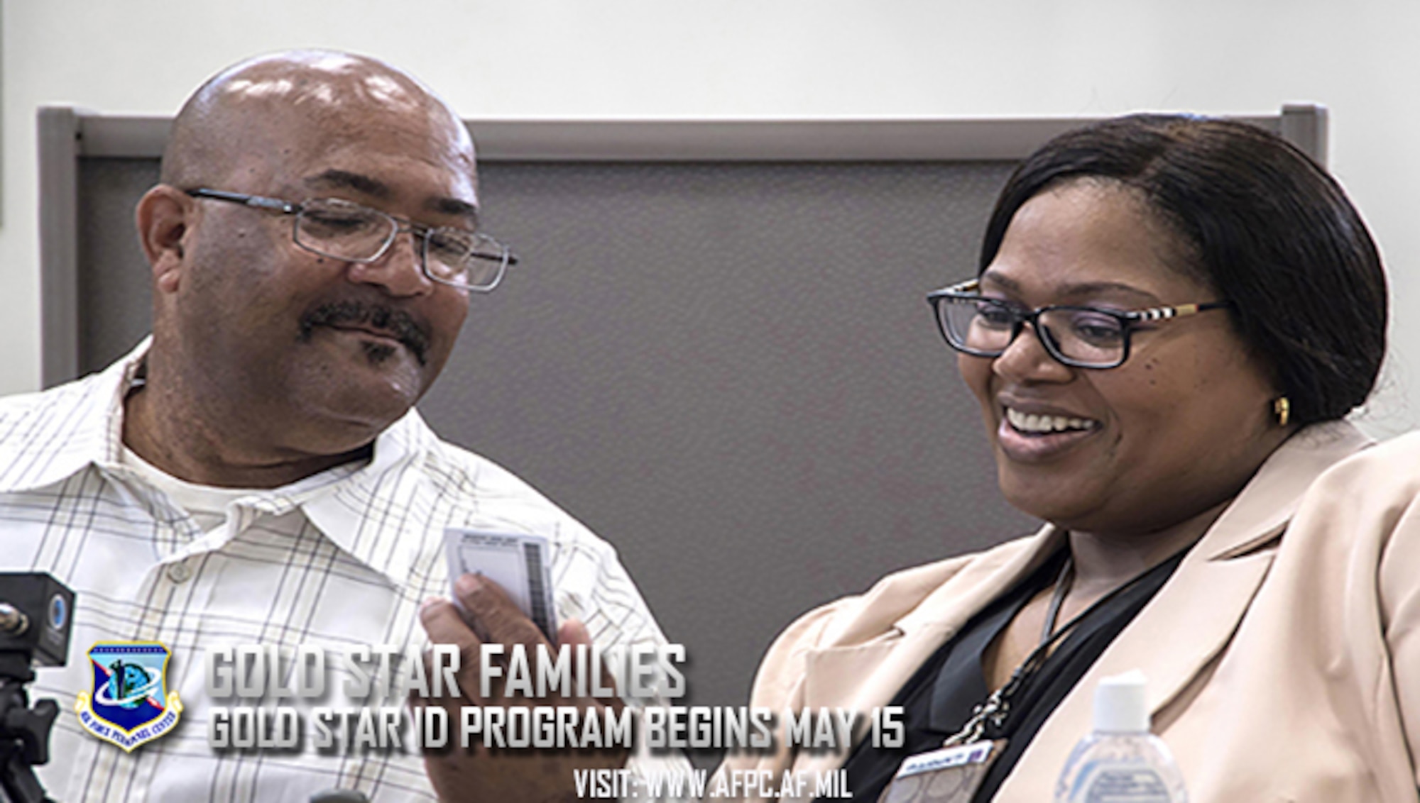 Michael L. Chavis, a Gold Star parent, shows his new Gold Star Base Access ID card to Carla Diamond, a U.S. Air Force Headquarters community readiness consultant, at Joint Base Andrews, Md., May 1, 2017. These cards are part of an Air Force initiative allowing Gold Star family members, immediate relatives of deceased Airmen, unescorted access to Air Force installations to visit buried loved ones, attend base events, and stop by Airmen and mily Readiness Centers for support. (U.S. Air Force photo/Senior Airman Jordyn Fetter)