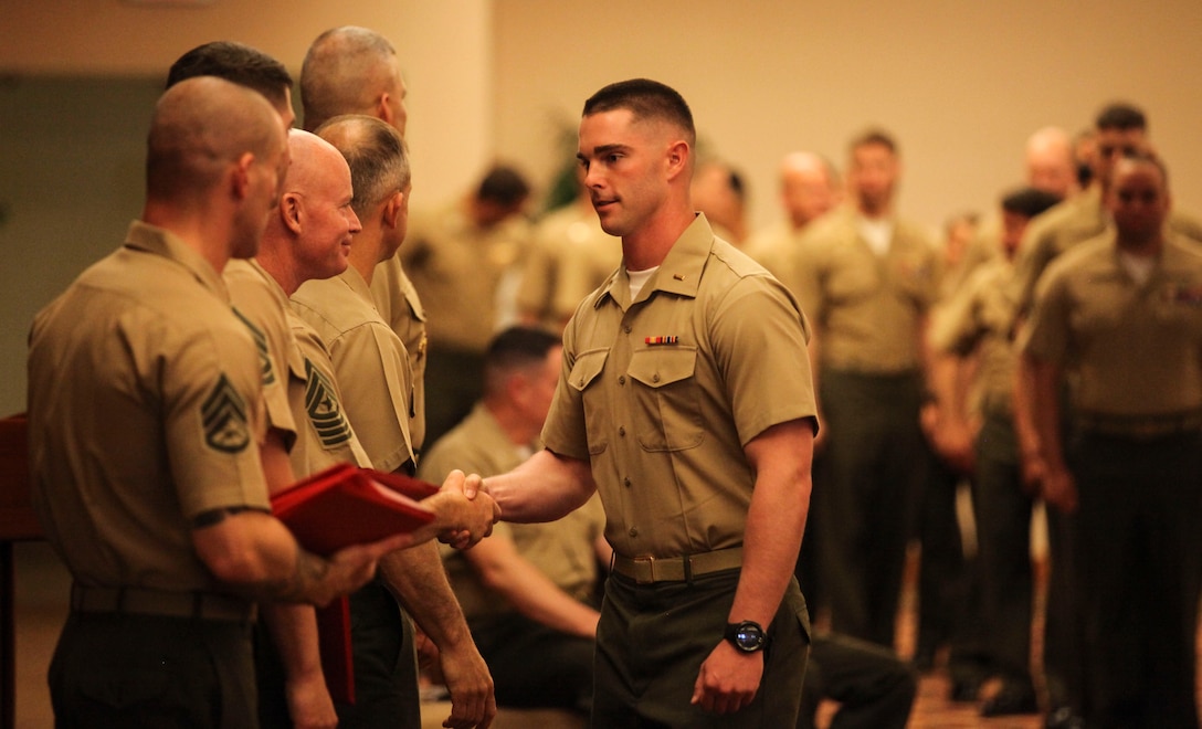 2nd Lt. Stephen Abernathy receives his Weapons and Tactics Instructor Course 2-17 certification during a ceremonial graduation at Marine Corps Air Station Yuma, Ariz., April 30, 2017. WTI is a seven week period of instruction that incorporates Marine Corps planning and implementation of advanced air and ground tactics through a series of escalating evolutions in order to produce certified Weapons and Tactics Instructors. More than 200 Marines and Sailors graduated from this class of WTI. Abernathy is a low altitude air defense officer assigned to 2nd Low Altitude Air Defense Battalion, Marine Air Control Group 28, 2nd Marine Aircraft Wing. (U.S. Marine Corps photo by Lance Cpl. Cody Lemons/Released)