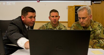 Dr. DJ Hovermale, the senior principal social engineer for the cyber exercise assessment studies and analysis division at Science Applications International Corporations (SAIC) out of Huntsville, Al., and Col. John Zierdt, the Army Reserve Cyber Shield Exercise leader of the 75th Training Command, Golf Training Division, out of Birmingham, Al., explain white cell operations to Col. Michael D. Smith, commander for the Army Reserve Cyber Operations Group out of Adelphi, Md., during Cyber Shield 17 at Camp Williams, Utah, May 2, 2017. Cyber Shield is a National Guard exercise, in cooperation with U.S. Army Reserve, that provides Soldiers, Air men and civilians from several sates and territories the opportunity to test their skills in response to cyber-incidents in a multi-service environment. (Army Reserve photo by Sgt. Stephanie Ramirez)