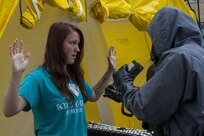 Civilian role player Cheyenne Patton, a North Vernon, Ind., resident, goes through decontamination following a mock nuclear disaster at the Muscatatuck Urban Training Center, April 28, 2017. The U.S. Army Reserve’s Guardian Response 2017 is a multi-component training exercise designed to validate more than 4,000 service members in Defense Support of Civil Authorities in the event of a Chemical, Biological, Radiological and Nuclear catastrophe. This year's exercise simulated an improvised nuclear device explosion with a source region electromagnetic pulse out to more than four miles. The 84th Training Command hosted this exercise and the 78th Training Division, headquartered in Joint Base McGuire-Dix-Lakehurst, New Jersey, conducted the training. (U.S. Army Reserve photo by Sgt. Beth Raney, 343rd Mobile Public Affairs Detachment)