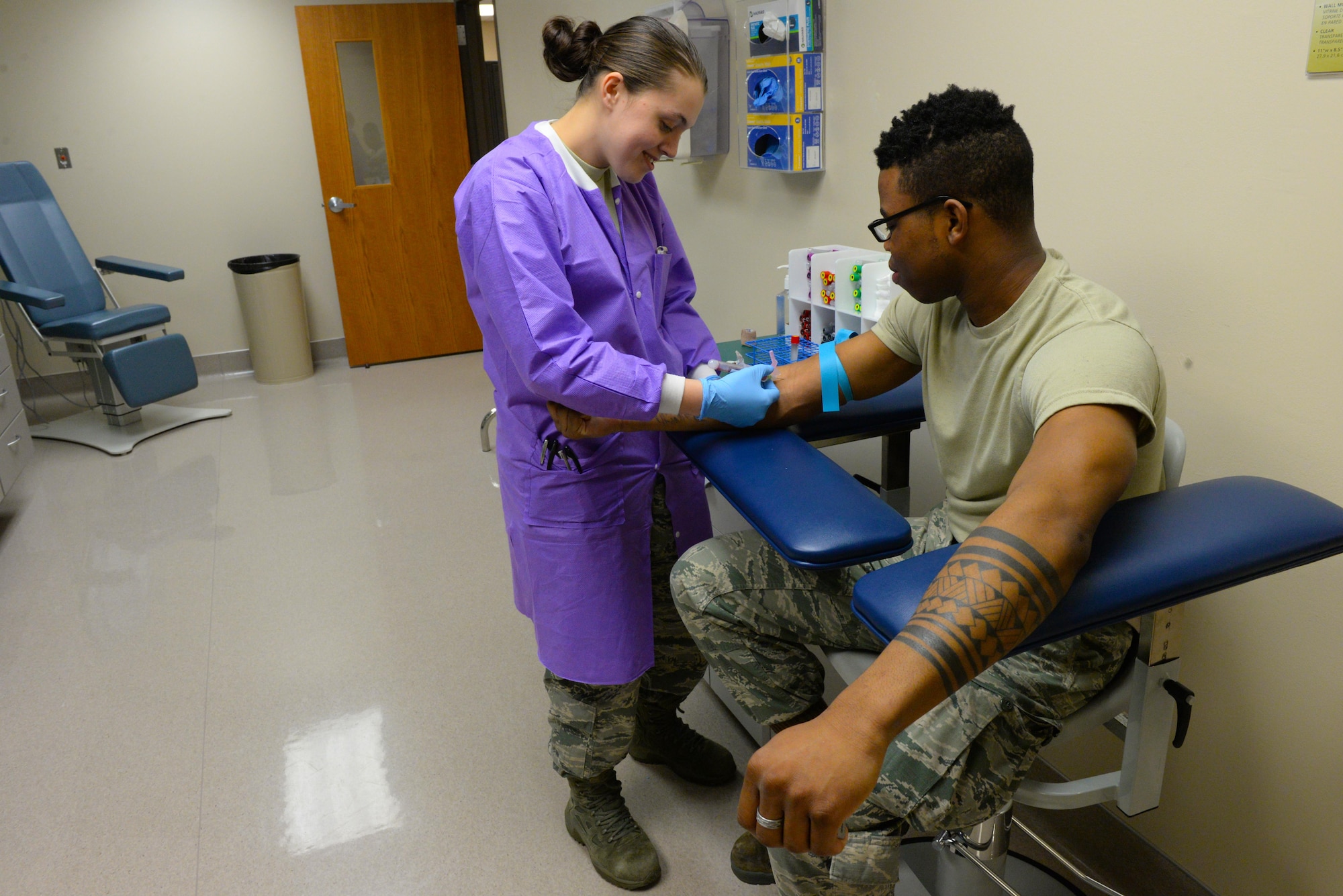 Airman 1st Class Kristen Lowder, a medical laboratory technician assigned to the 28th Medical Support Squadron, takes a blood sample from Airman 1st Class Von Black, a food services apprentice assigned to the 28th Force Support Squadron, inside the medical laboratory at Ellsworth Air Force Base, S.D., April 24, 2017. Lowder is the project officer for the 28th Medical Group bone marrow donation week. (U.S. Air Force photo by Airman Nicolas Z. Erwin)