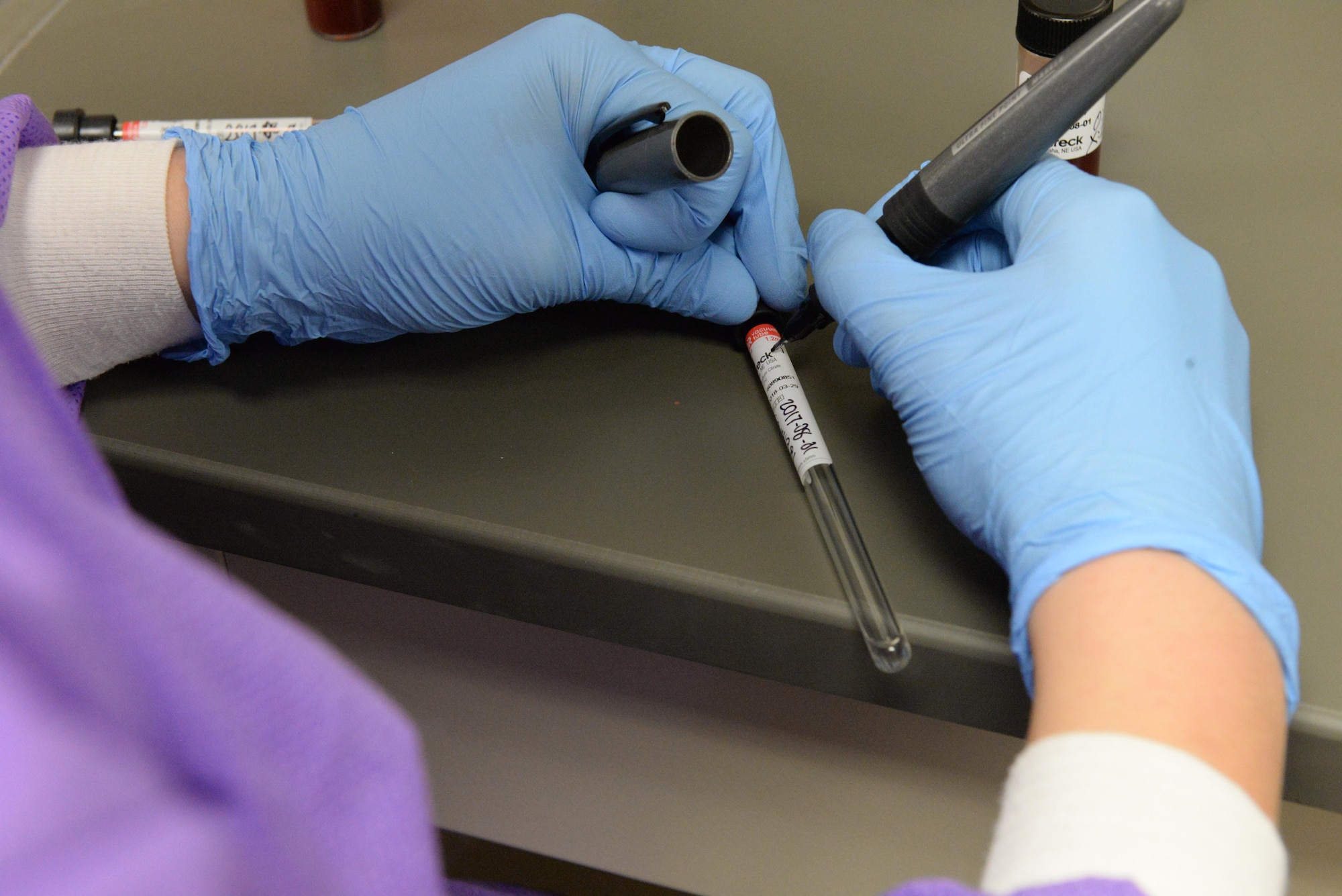 Airman 1st Class Kristen Lowder, a medical laboratory technician assigned to the 28th Medical Support Squadron, labels a test vial to reset a coagulation machine inside the medical laboratory at Ellsworth Air Force Base, S.D., April 24, 2017. The laboratory equipment must be quality checked every morning to ensure proper readings. (U.S. Air Force photo by Airman Nicolas Z. Erwin)