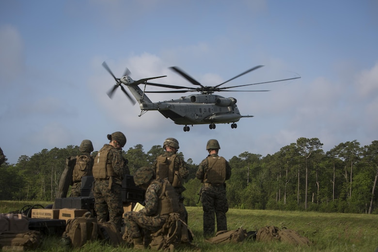 CAMP LEJEUNE, N.C. – Marines and sailors with the Command Element, Special Purpose Marine Air-Ground Task Force - Southern Command, standby to load gear while a CH-53E Super Stallion helicopter lands during General Exercise 2 at Marine Corps Base Camp Lejeune, North Carolina, April 29, 2017. The Marines simulated a noncombatant evacuation operation in order to prepare for crisis response situations they could face during their deployment to Central America. (U.S. Marine Corps photo by Sgt. Ian Leones)