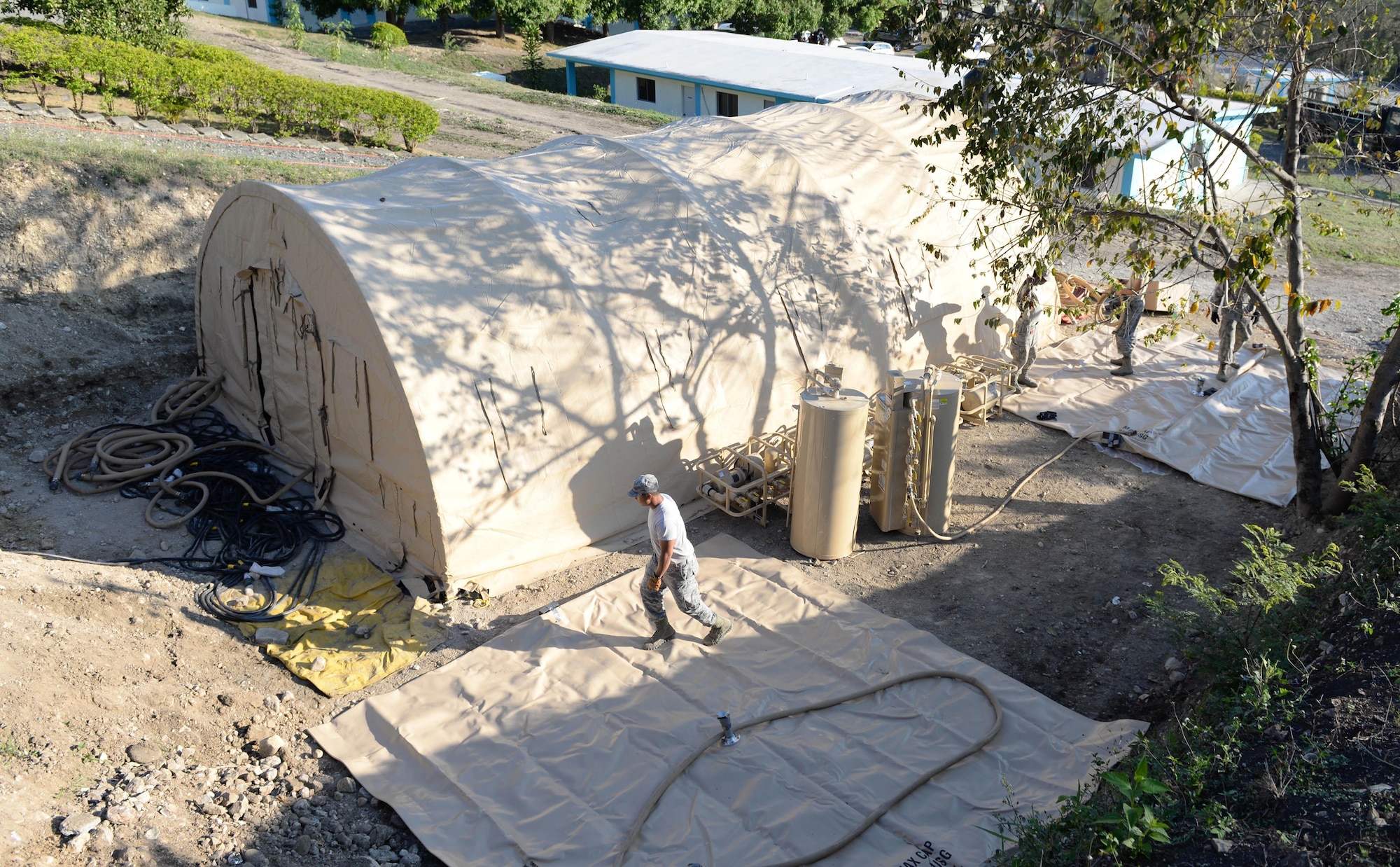 U.S. Airmen deployed from the 635th Materiel Maintenance Squadron out of Holloman Air Force Base, N.M., work to connect two 3,000-gallon water bladders to a newly-constructed laundry facility in the Dominican Republic, March 29, 2017, as part of NEW HORIZONS 2017. The 635th MSS is only squadron in the Air Force that provides Basic Expeditionary Airfield Resources, or BEAR, assets to a variety of DoD missions like NEW HORIZONS, which ensures U.S. forces remain prepared for real-world deployments in support of contingency, humanitarian assistance, and disaster relief operations. (U.S. Air Force photo by Staff Sgt. Timothy M. Young)