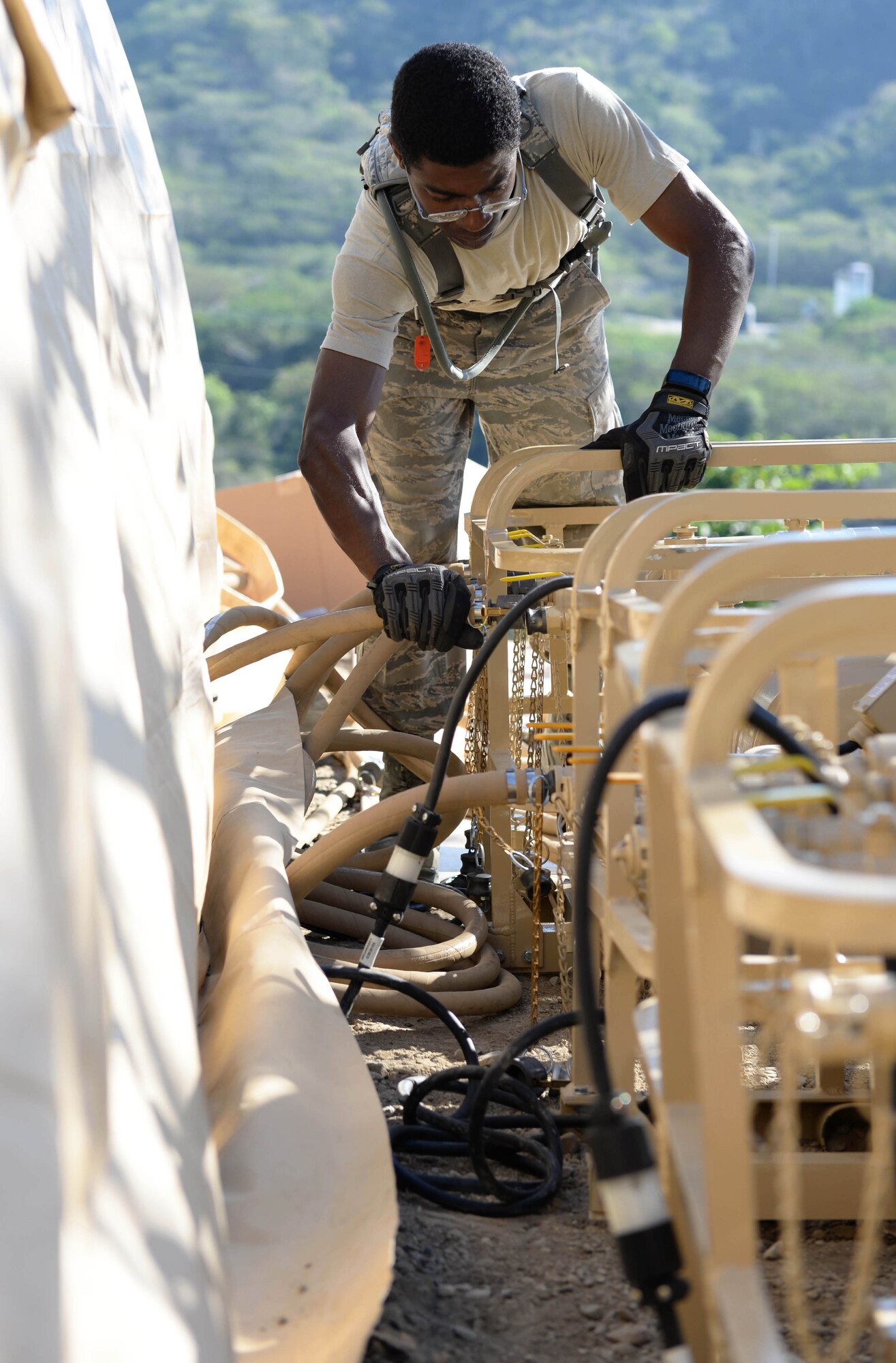 U.S. Air Force Staff Sgt. Stark Sarrazin, a water and fuel systems maintenance craftsman with the 635th Materiel Maintenance Squadron out of Holloman Air Force Base, N.M., attaches hoses to pumps that will supply water to a newly-constructed laundry facility in the Dominican Republic, March 29, 2017, as part of NEW HORIZONS 2017. The pumps will supply clean water as well as pull dirty water from 10 washers that will support approximately 450 Airmen, Soldiers, Marines and Sailors participating in the annual exercise on a rotational basis. (U.S. Air Force photo by Staff Sgt. Timothy M. Young)