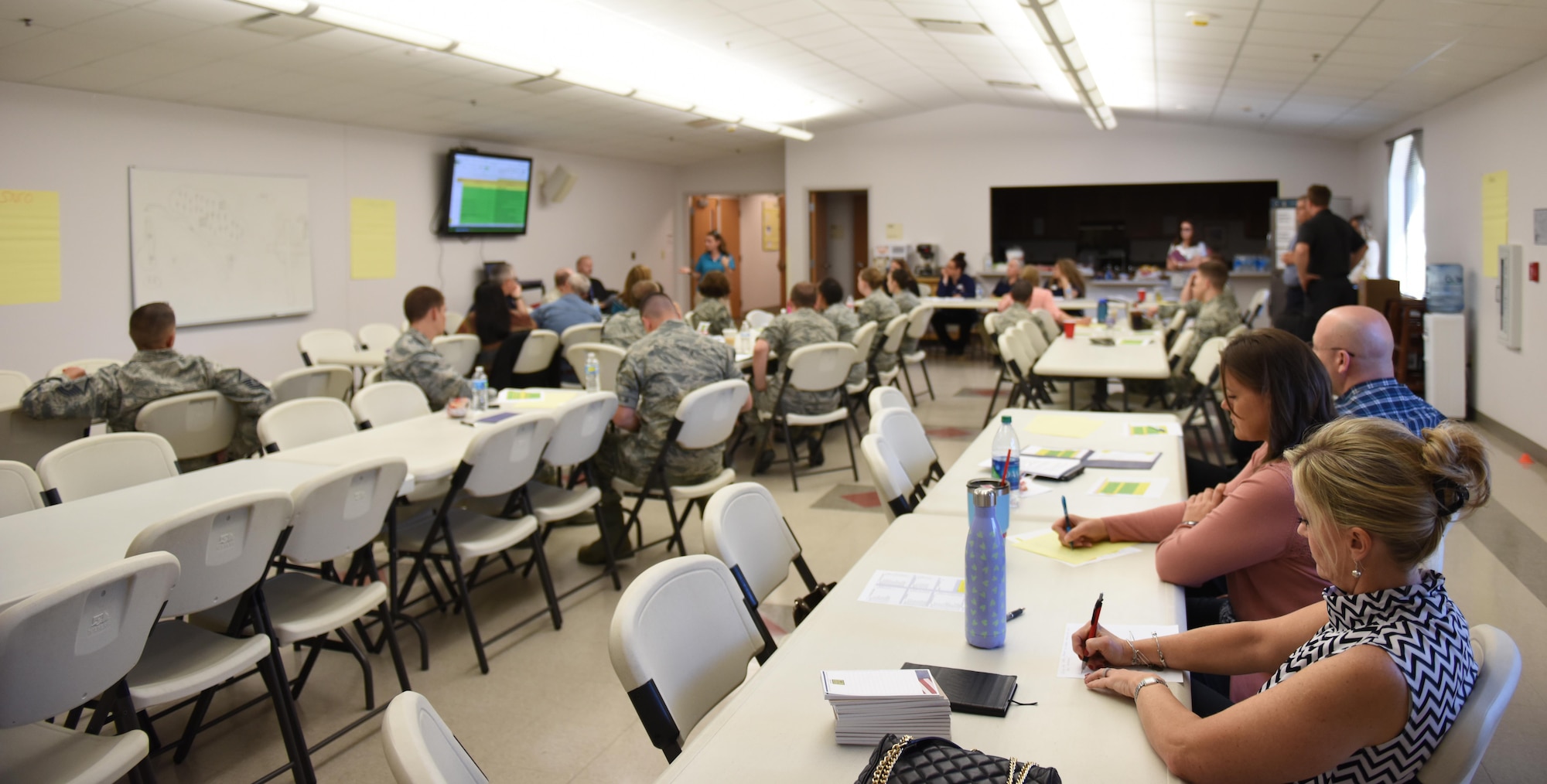 Goodfellow members take notes during the Caring for People Forum at Taylor Chapel on Goodfellow Air Force Base, Texas, May 4, 2017. Base members from a wide range of positions and ranks volunteered to discuss improvements during the forum. (U.S. Air Force photo by Airman 1st Class Caelynn Ferguson/ Released)