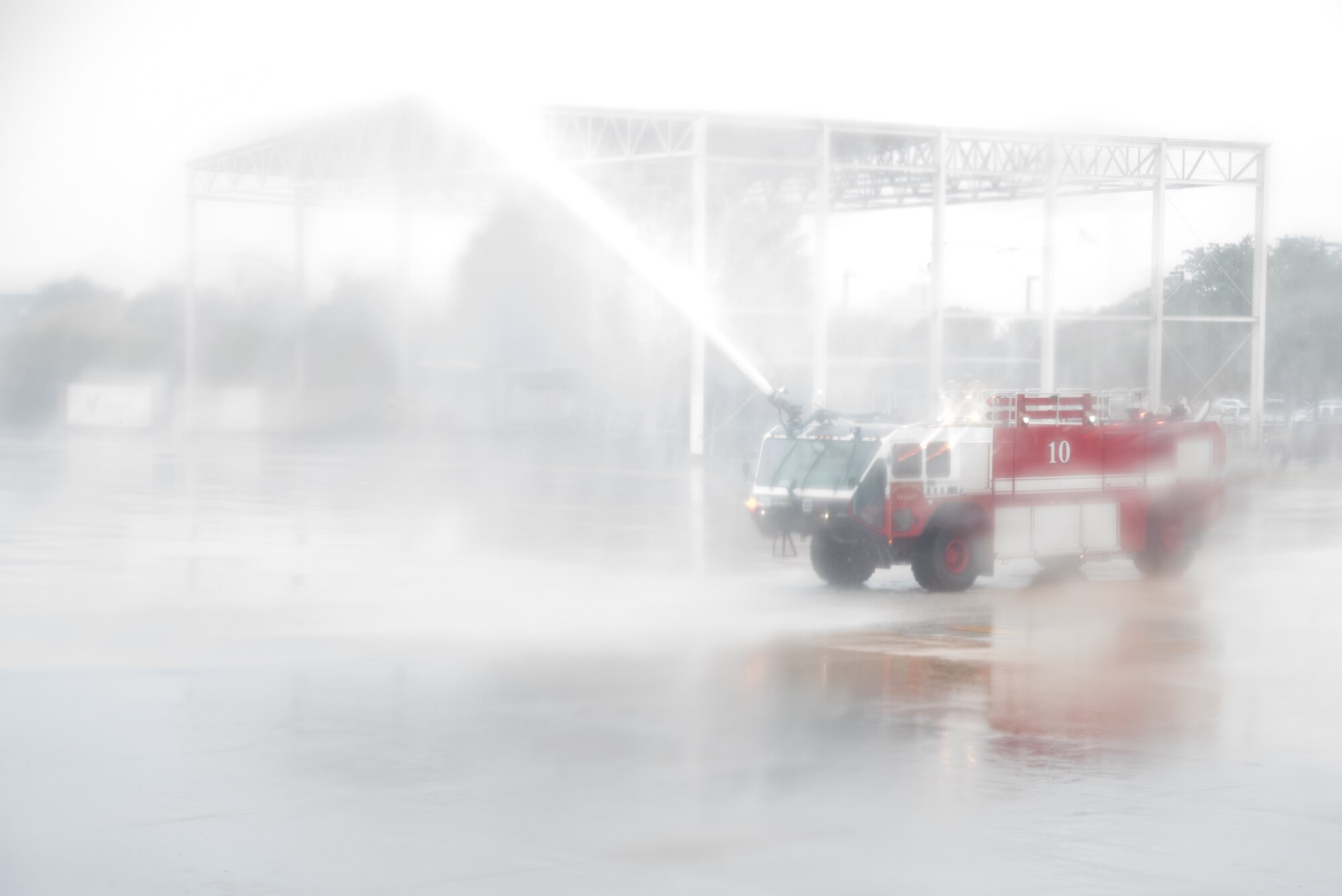 A Keesler Fire Department fire truck sprays a water arch over a C-130J Super Hercules Aircraft during the final flight of Col. Michael Manion before his retirement. (U.S. Air Force photo/Staff Sgt. Heather Heiney)