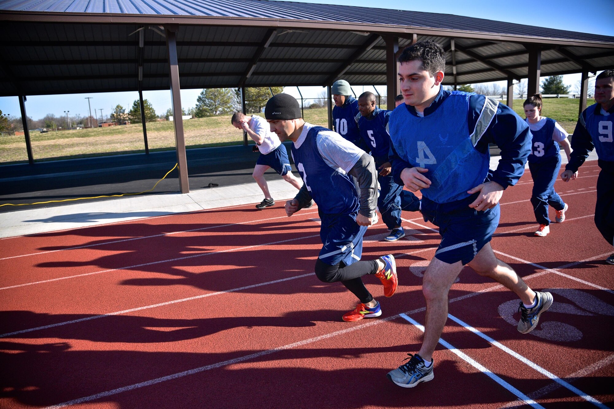 Lt. Col. Troy Appel, number two jersey, middle, former 932nd Airlift Wing Aircraft Maintenance Squadron commander, now with Air Mobility Command at Scott Air Force Base, begins his Air Force physical fitness test March 4, 2017 at the James Gym track, Scott Air Force Base, Illinois.  (U.S. Air Force photo by Tech. Christopher Parr)