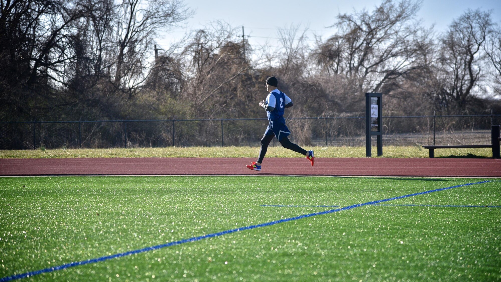 Lt. Col. Troy Appel, number two jersey, former 932nd Airlift Wing Aircraft Maintenance Squadron commander, now with Air Mobility Command at Scott Air Force Base, completes his first lap during his Air Force physical fitness test March 4, 2017 at the James Gym track, Scott Air Force Base, Illinois.  (U.S. Air Force photo by Tech. Christopher Parr)