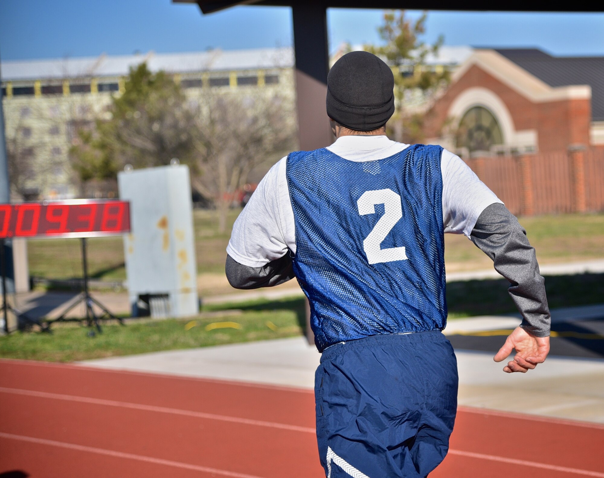 Lt. Col. Troy Appel, former 932nd Airlift Wing Aircraft Maintenance Squadron commander, now with Air Mobility Command at Scott Air Force Base, crosses the finish line with a time of 9:38 after completing his Air Force physical fitness test March 4, 2017 at the James Gym track, Scott Air Force Base, Illinois.  (U.S. Air Force photo by Tech. Christopher Parr)