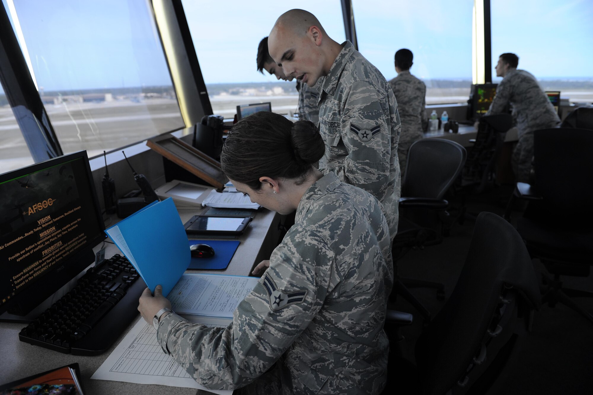 Airmen 1st Class Tristen Saucier and Chris Kondysar, air traffic control apprentices with the 1st Special Operations Support Squadron, update training records at Hurlburt Field, Fla., May 3, 2017. Air traffic controllers provide safe and organized flow of aircraft on the flight line and in the air by monitoring and keeping track of scheduled incoming and departing aircraft. (U.S. Air Force photo by Airman 1st Class Isaac O. Guest IV)