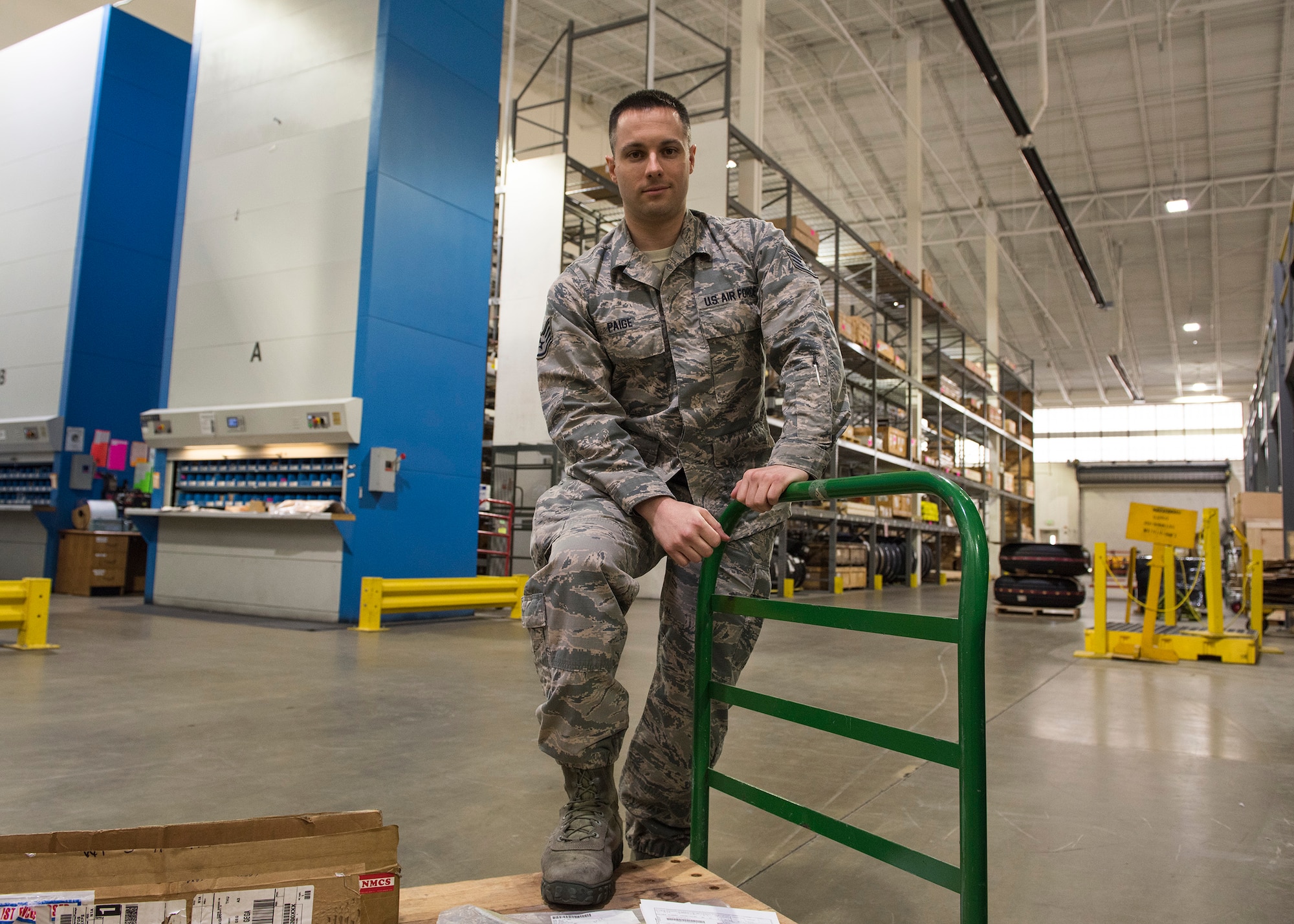 Staff Sgt. Brandon Paige, 92nd Logistic Readiness Squadron NCO in charge of the Flight Service Center, pauses while moving parts for shipping Mar. 22, 2017, at Fairchild Air force Base, Washington. The Flight Service Center handles all of the bases parts shipping and tracking logistic needs.