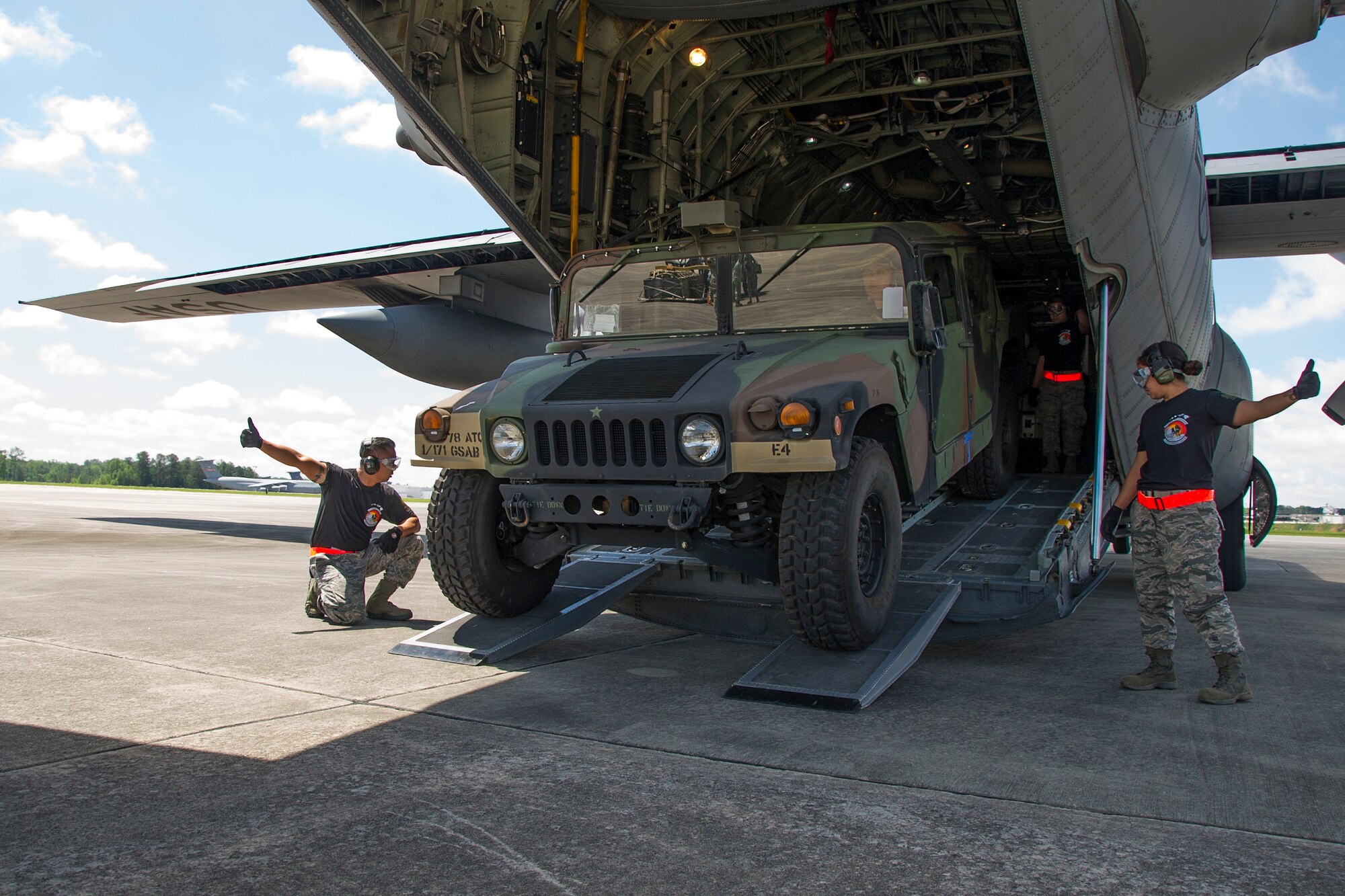 Reserve Citizen Airmen Tech. Sgt. Eric Ignacio, left, of Honolulu, and Staff Sgt. Amber Picon, of Waipahu, give a thumbs up to Tech. Sgt. Dennis Dedicatiria, of Ewa Beach, while offloading a Humvee from the back of a C-130 Hercules aircraft during the Port Dawg Challenge at Dobbins Air Reserve Base, Ga., April 25, 2017.  The 48th Aerial Port Squadron was one of 23 teams competing in the 4th biennial Air Force Reserve Command's Port Dawg Challenge, which was designed to test and maintain the camaraderie of aerial port Airmen while promoting professionalism, leadership, training and communication between "Port Dawgs." The 48th APS is located on Joint Base Pearl Harbor-Hickam, Hawaii, and a component of the Air Force Reserve, providing expertise in all areas of air terminal operations to include aircraft loading, cargo processing and inspecting, passenger services, aircraft fleet services and aerial port command and control. (U.S. Air Force photo by Master Sgt. Theanne K. Herrmann)