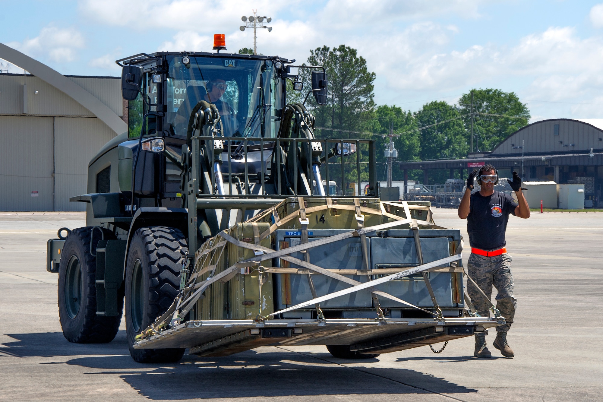 Reserve Citizen Airmen Master Sgt. Alfred Van Gieson, of Nanakuli, Hawaii, directs Tech. Sgt. Dennis Dedicatoria, of Ewa Beach, Hawaii, as he positions a pallet of equipment using a 10K forklift during the Port Dawg Challenge at Dobbins Air Reserve Base, Ga., April 25, 2017.  The 48th Aerial Port Squadron was one of 23 teams competing in the 4th biennial Air Force Reserve Command's Port Dawg Challenge, which was designed to test and maintain the camaraderie of aerial port Airmen while promoting professionalism, leadership, training and communication between "Port Dawgs." The 48th APS, located on Joint Base Pearl Harbor-Hickam, Hawaii, is a component of the Air Force Reserve, providing expertise in all areas of air terminal operations to include aircraft loading, cargo processing and inspecting, passenger services, aircraft fleet services and aerial port command and control. (U.S. Air Force photo by Master Sgt. Theanne K. Herrmann)