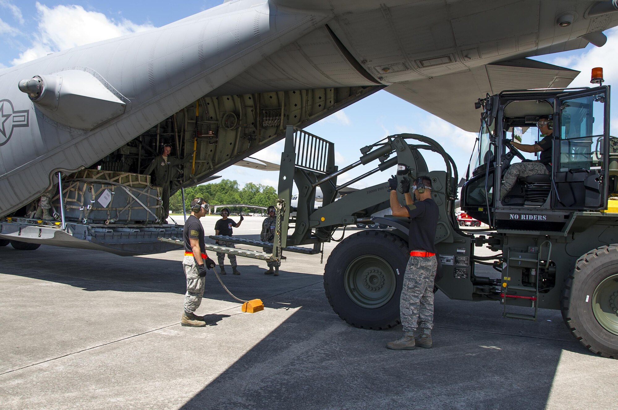 Reserve Citizen Airmen members from the 48th Aerial Port Squadron, based out of Joint Base Pearl Harbor-Hickam, Hawaii, uses a 10K forklift to load a pallet onto a C-130 Hercules aircraft during the Port Dawg Challenge at Dobbins Air Reserve Base, Ga., April 25, 2017. The 48th Aerial Port Squadron was one of 23 teams competing in the 4th biennial Air Force Reserve Command's Port Dawg Challenge, which was designed to test and maintain the camaraderie of aerial port Airmen while promoting professionalism, leadership, training and communication between "Port Dawgs." The 48th APS is a component of the Air Force Reserve, providing expertise in all areas of air terminal operations to include aircraft loading, cargo processing and inspecting, passenger services, aircraft fleet services and aerial port command and control. (U.S. Air Force photo by Master Sgt. Theanne K. Herrmann)