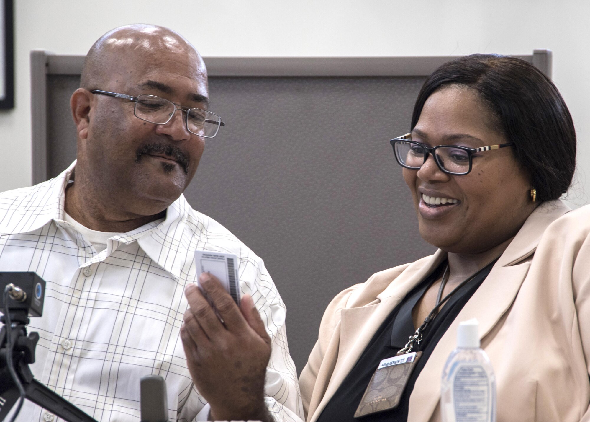 Michael L. Chavis, left, Gold Star parent, shows his new Gold Star Base Access ID card to Carla Diamond, right, U.S. Air Force Headquarters community readiness consultant, at Joint Base Andrews, Md., May 1, 2017. These cards are part of an Air Force initiative allowing Gold Star family members, immediate relatives of deceased Airmen, unescorted access to Air Force installations to visit buried loved ones, attend base events, and stop by Airmen and Family Readiness Centers for support. The Air Force initiative refers to parents, grandparents, siblings and adult children of Airmen killed in action, international terrorist attack against the U.S. or military operations while serving outside the U.S. as part of a peacekeeping force. (U.S. Air Force photo by Senior Airman Jordyn Fetter)