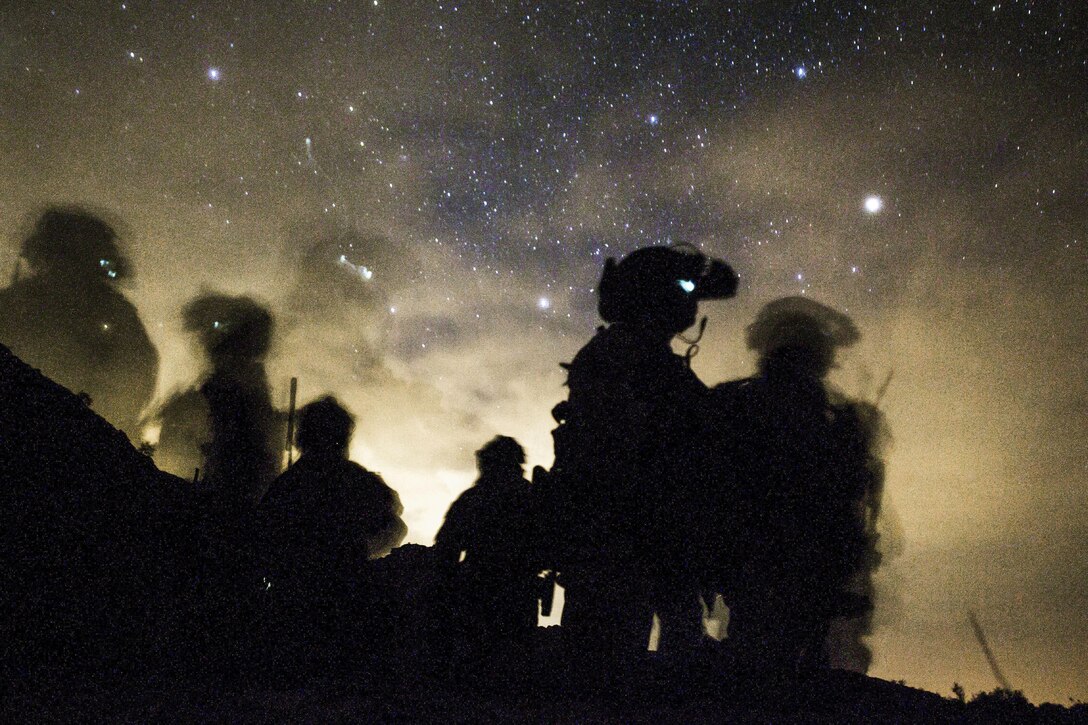 Marines await departure during a weapons and tactics instructors course final exercise near Yuma, Arizona, April 27, 2017. The Marines are assigned to the 1st Marine Raider Battalion, Marine Raider Regiment, Marine Corps Forces Special Operations Command. Marine Corps photo by Lance Cpl. Clare Shaffer