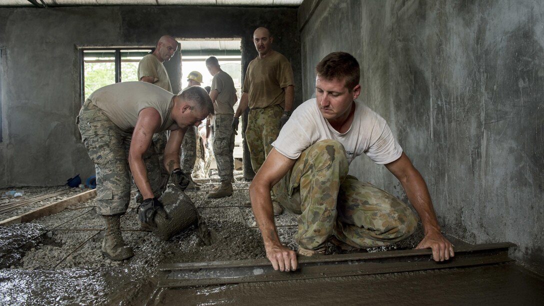 U.S. Airmen and Australian Soldiers pour floor concrete during Balikatan 2017 in Ormoc City, Leyte, April 29, 2017. U.S. military and Australian Army engineers worked together with Armed Forces of the Philippines soldiers to build new classrooms at Margen Elementary School in Ormoc City. Balikatan is an annual U.S.-Philippine bilateral military exercise focused on a variety of missions, including humanitarian assistance and disaster relief, counterterrorism and other combined military operations. 