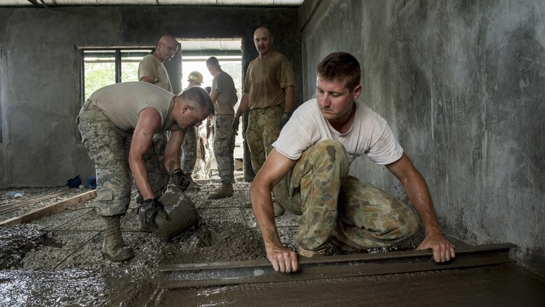 U.S. Airmen and Australian Soldiers pour floor concrete during Balikatan 2017 in Ormoc City, Leyte, April 29, 2017. U.S. military and Australian Army engineers worked together with Armed Forces of the Philippines soldiers to build new classrooms at Margen Elementary School in Ormoc City. Balikatan is an annual U.S.-Philippine bilateral military exercise focused on a variety of missions, including humanitarian assistance and disaster relief, counterterrorism and other combined military operations. 