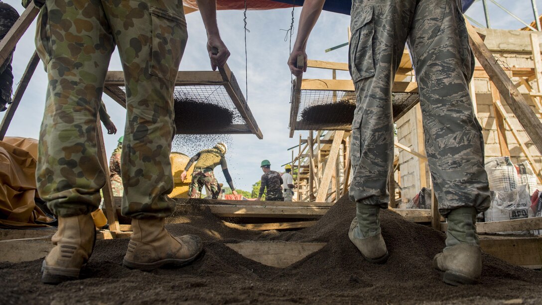 Australian Soldiers and U.S. Airmen screen sand for wall plaster during Balikatan 2017 in Ormoc City, Leyte, April 29, 2017. U.S. military and Australian Army engineers worked together with the Armed Forces of the Philippines to build new classrooms at Margen Elementary School in Ormoc City. Balikatan is an annual U.S.-Philippine bilateral military exercise focused on a variety of missions, including humanitarian assistance and disaster relief, counterterrorism and other combined military operations. 