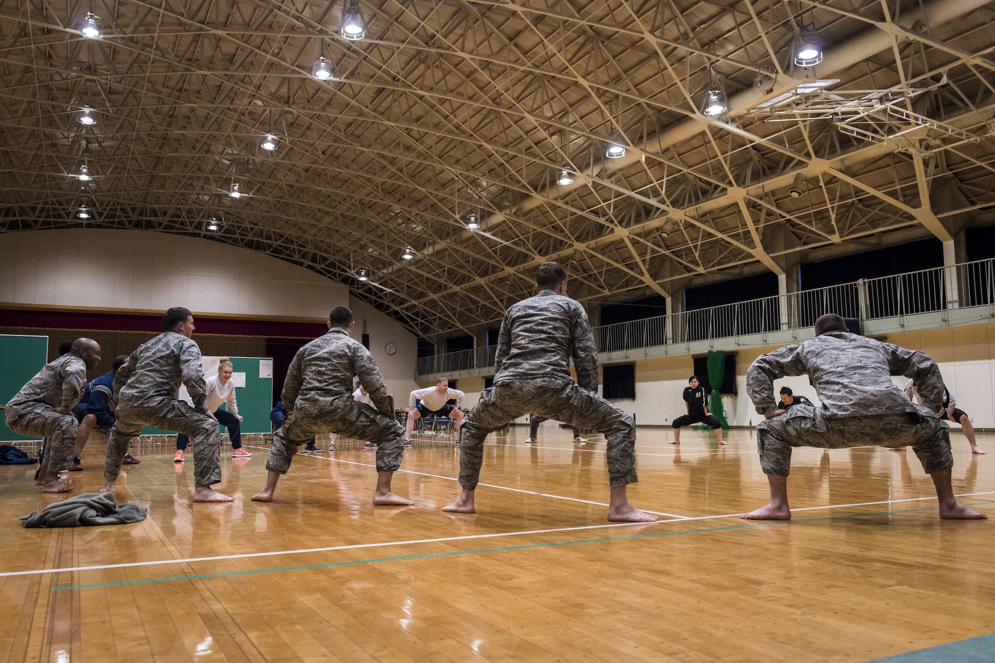 U.S. and Japanese Airmen stretch prior to learning a traditional Japanese dance during a 10-day U.S.-Japan Bilateral Career Training, at Chitose Air Base, Japan, April 12, 2017. Over the next hour and a half, the Koku-Jieitai and U.S. Airmen from Misawa Air Base, Japan, danced while learning more about each other’s cultural background helping to increase the two-nation’s interoperability. Cultural exchanges like this dance strengthen the U.S.-Japan security alliance by humanizing each nation’s service members bringing them closer as allies and friends. Koku-Jieitai is the traditional term for Japan Air Self Defense Force used by the Japanese. (U.S. Air Force photo by Tech. Sgt. Benjamin W. Stratton)