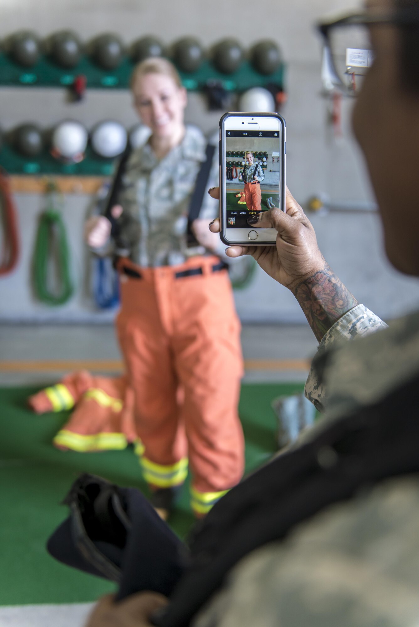 U.S. Air Force Tech. Sgt. Jessica Nienheuser, left, the 35th Medical Support Squadron patient administration section chief, tries on some Koku-Jieitai firefighter pants as U.S. Air Force Staff Sgt. Ebony Jenkins, right, a 35th Security Forces Squadron member, takes her photo during a 10-day U.S.-Japan Bilateral Career Training at Chitose Air Base, Japan, April 17, 2017. The U.S. Airmen experienced numerous unit tours across the installation. The tours provided the Misawa Air Base NCOs opportunities to ask questions and really understand the operational capabilities the Hokkaido base brings to the fight. Koku-Jieitai is the traditional term for Japan Air Self Defense Force used by the Japanese. (U.S. Air Force photo by Tech. Sgt. Benjamin W. Stratton)