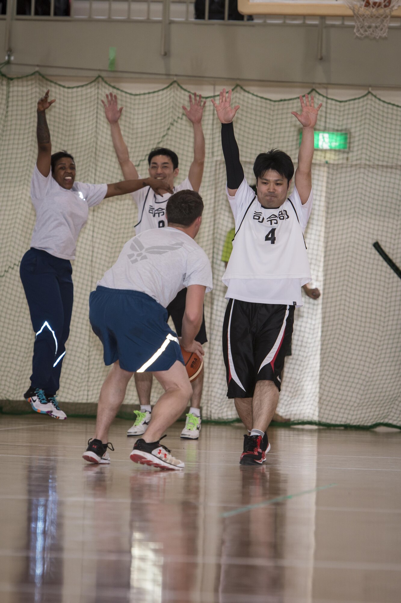 U.S. Air Force Staff Sgt. Jarrod Clark, center, a 35th Aircraft Maintenance Squadron crew chief, readies for a shot at the basket as two Koku-Jieitai members and U.S. Air Force Staff Sgt. Ebony Jenkins, left, a 35th Security Forces Squadron member, attempt to block his shot during a 10-day U.S.-Japan Bilateral Career Training at Chitose Air Base, Japan, April 17, 2017. The U.S. Airmen joined their Koku-Jieitai counterparts for a friendly game of basketball aimed to bring to the nations together on the court. While Clark did miss this shot, he made many others with help from his Koku-Jieitai teammates. Just as he experienced on the flightline repairing and maintaining jets, his teammates always had his back on the court. Koku-Jieitai is the traditional term for Japan Air Self Defense Force used by the Japanese. (U.S. Air Force photo by Tech. Sgt. Benjamin W. Stratton)