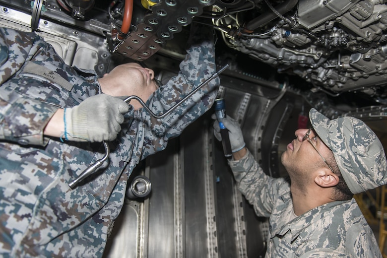 Koku-Jieitai Tech. Sgt. Takuro Inazawa, left, a 2nd Air Wing Field Maintenance Squadron engine technician, and U.S. Air Force Tech. Sgt. Radell Mitchell, right, a 35th Maintenance Group quality assurance inspector, work side-by-side installing borescope plugs during a 10-day U.S.-Japan Bilateral Career Training at Chitose Air Base, Japan, April 18, 2017. The borescope plugs allow maintenance Airmen to inspect the internal workings of engine components. Mitchell said Inazawa taught him how Koku-Jieitai maintainers inspect their F-15J Eagles before and after take-off specifically stating just how clean and tidy they keep their jets. “I’ve never seen a jet so clean and grease free before; it’s obvious they have a lot of pride in the work they do for their country,” he said. Mitchell, along with nine other U.S. Airmen visited Chitose from Misawa Air Base, Japan. Koku-Jieitai is the traditional term for Japan Air Self Defense Force used by the Japanese. (U.S. Air Force photo by Tech. Sgt. Benjamin W. Stratton)