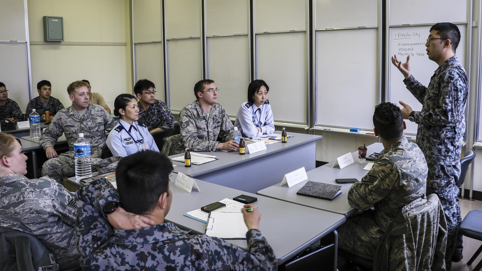 Koku-Jieitai Senior Airman Takashi Shibuya, a 2nd Air Wing Armament Maintenance Squadron armament technician, explains his view of leadership with U.S. and other Japanese Airmen during a 10-day U.S.-Japan Bilateral Career Training at Chitose Air Base, Japan, April 19, 2017. The U.S. and Japanese participants broke out into three groups, each allowed 30 minutes to discuss their top three leadership traits and then present their findings with the rest of the participants. Koku-Jieitai is the traditional term for Japan Air Self Defense Force used by the Japanese. (Japanese Air Self-Defense Force photo by Chief Master Sgt. Katsuaki Imazeki)