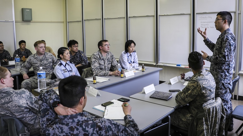 Koku-Jieitai Senior Airman Takashi Shibuya, a 2nd Air Wing Armament Maintenance Squadron armament technician, explains his view of leadership with U.S. and other Japanese Airmen during a 10-day U.S.-Japan Bilateral Career Training at Chitose Air Base, Japan, April 19, 2017. The U.S. and Japanese participants broke out into three groups, each allowed 30 minutes to discuss their top three leadership traits and then present their findings with the rest of the participants. Koku-Jieitai is the traditional term for Japan Air Self Defense Force used by the Japanese. (Japanese Air Self-Defense Force photo by Chief Master Sgt. Katsuaki Imazeki)
