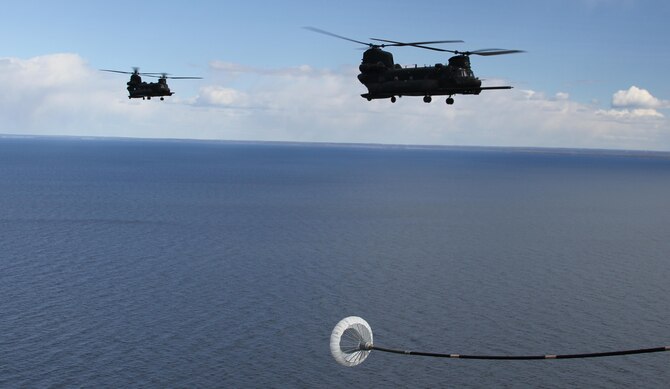 U.S. Army CH-47 Chinook helicopters prepare to conduct Helicopter Air-to-Air Refueling from a U.S. Air Force MC-130J Commando II over Karlsborg, Sweden during Exercise MARAP,  April 11, 2017.  Exercise MARAP allowed U.S. SOF the opportunity to integrate and train with partner nations in a unique and realistic training environment.  (U.S. Army Photo by Staff Sgt. Henry Gundacker, U.S. Special Operations Command Europe-Public Affairs)