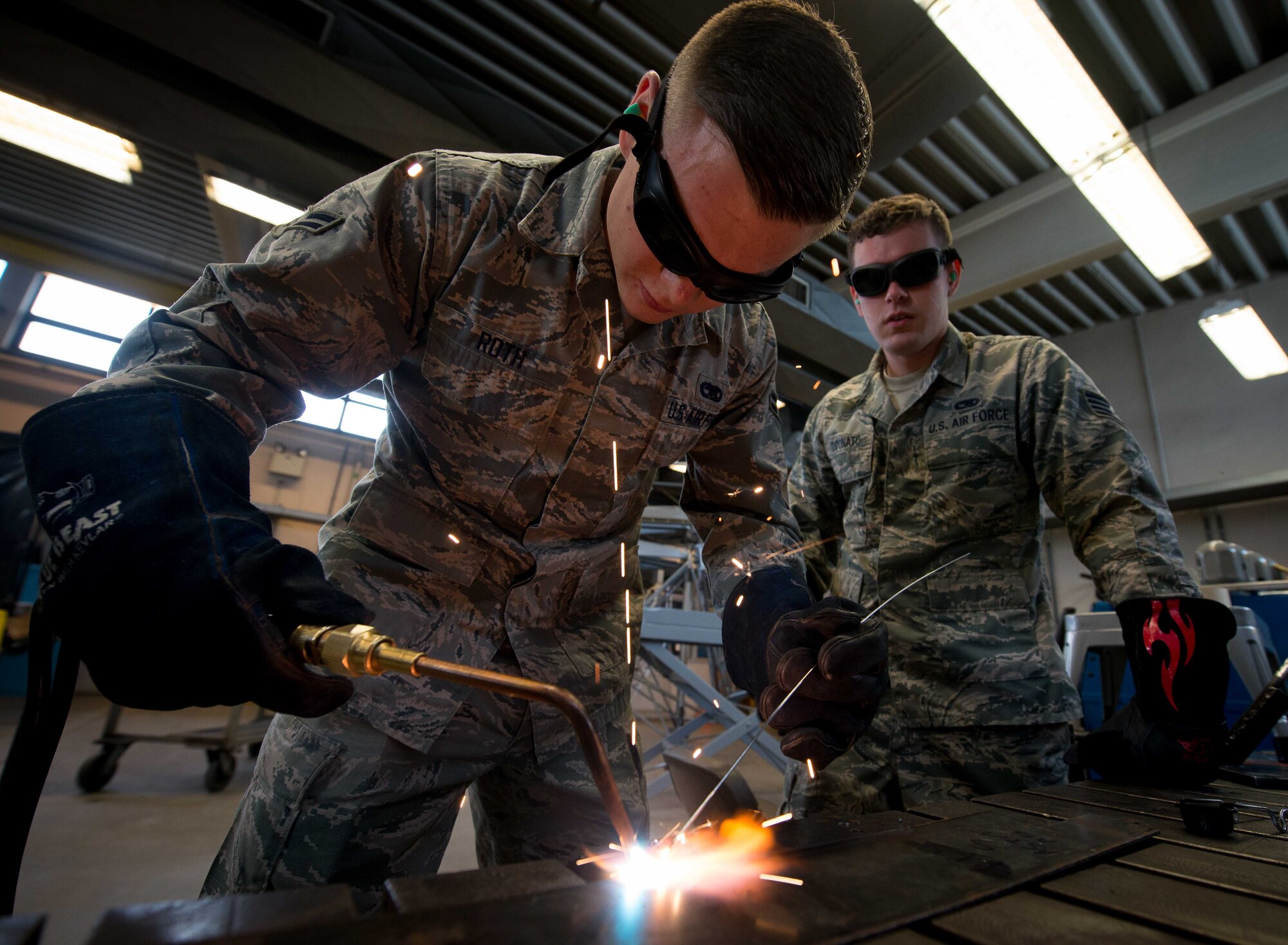 Staff Sgt. Brandon Didonato, 86th Maintenance Squadron aircraft metals technology technician, uses oxyacetylene welding while Airman 1st Class Joshua Roth, 86th MXS aircraft metals technology technician, observes on Ramstein Air Base, Germany, May 2, 2017. The 86th MXS Aircraft Metals Technology shop supports the flight line by creating tools and aircraft parts, including those that may otherwise be difficult or impossible to obtain through purchases because they are too far away or out of production. (U.S. Air Force photo by Senior Airman Elizabeth Baker/Released)