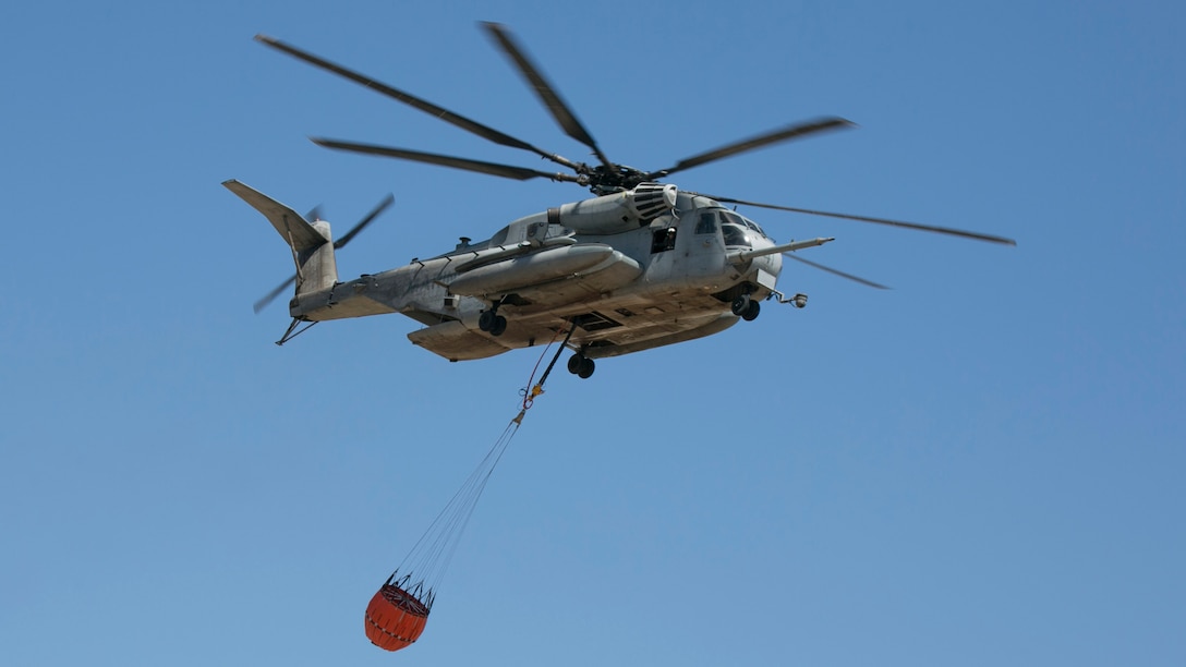 U.S. Marine Corps CH-53E Sea Stallion with Marine Heavy Helicopter (HMH) Squadron 361, Marine Aircraft Group 16, 3d Marine Aircraft Wing, carries a Bambi Bucket during flight on Marine Corps Base Camp Pendleton, San Diego, Calif., May 4, 2017. This exercise was conducted to simulate immediate response action drills according to established procedures during a fire event. 