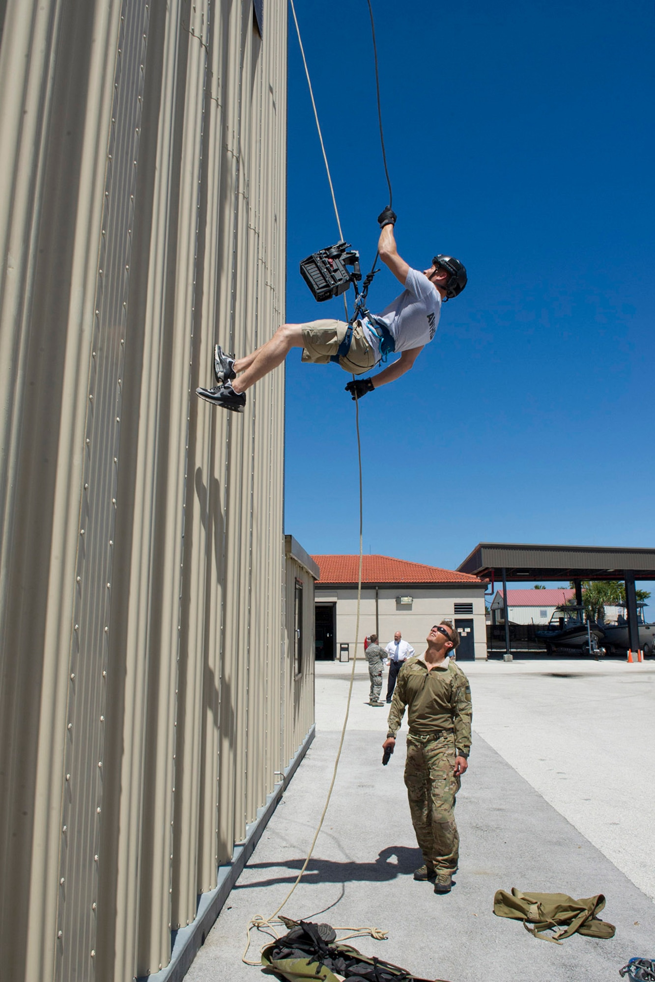 Tech. Sgt. Kyle Minshew, 308th Rescue Squadron pararescueman, guides American Ninja Warrior star Brent Steffensen as he rappels down the unit’s training tower April 21, 2017 at Patrick Air Force Base, Florida. Steffensen visited the base as part of the Alpha Warrior Military Tour. (U.S. Air Force photo/Phillip Sunkel)